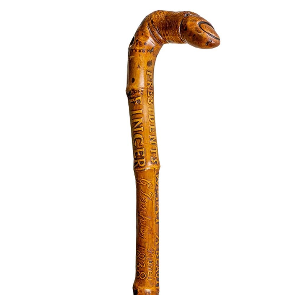 Circa 1838 Folk art walking stick  

An extremely rare and unusual commemorative walking stick. The main part of the stick is bamboo, with a grafted section of hardwood on the top which has been carved into the shape of a bent finger to form a