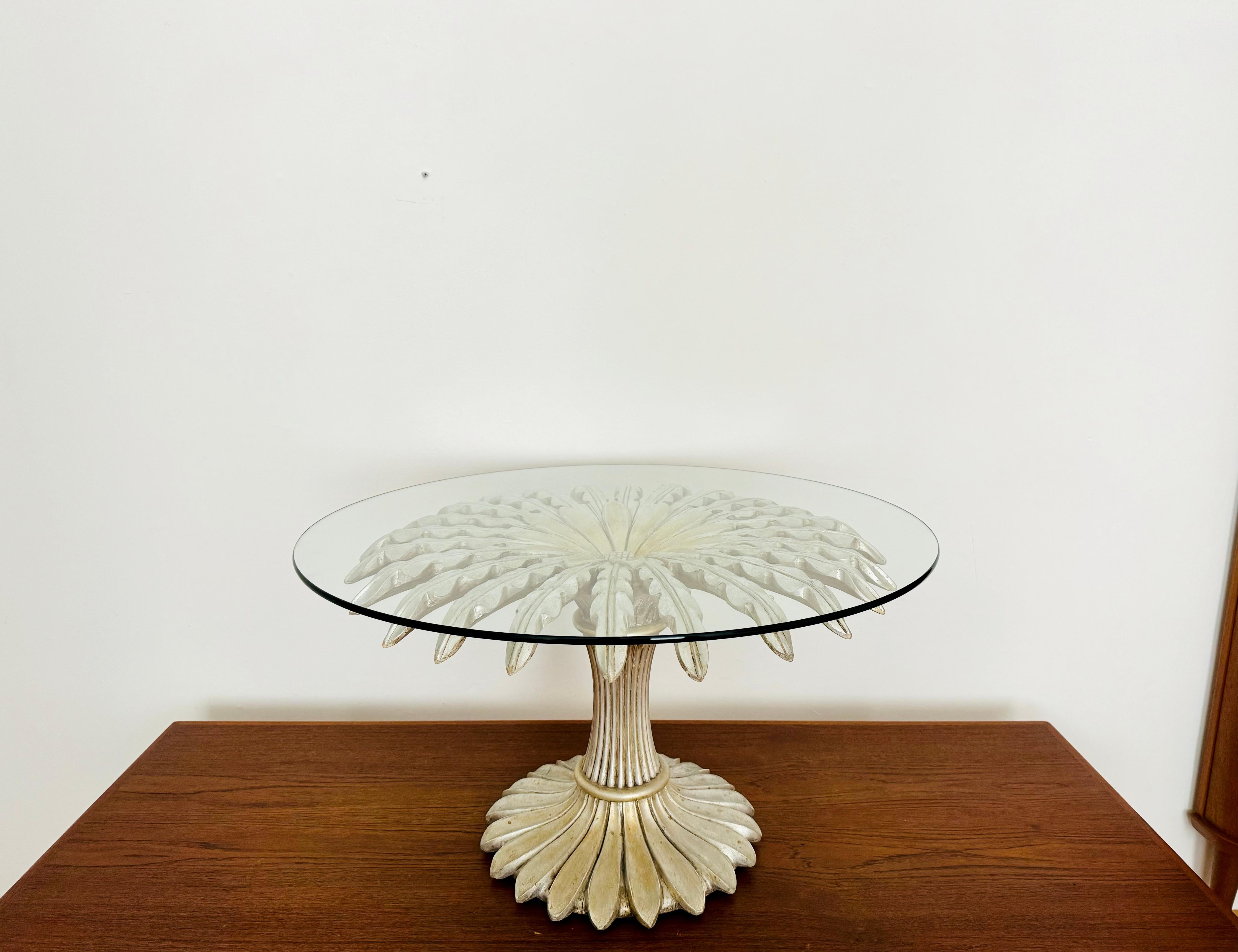 Exceptionally beautiful coffee or side table from the 1970s.
Wonderful design and an asset to any home.
The wooden frame was silver-plated.

Condition: 

Very good vintage condition with slight signs of age-related wear.
The glass top is