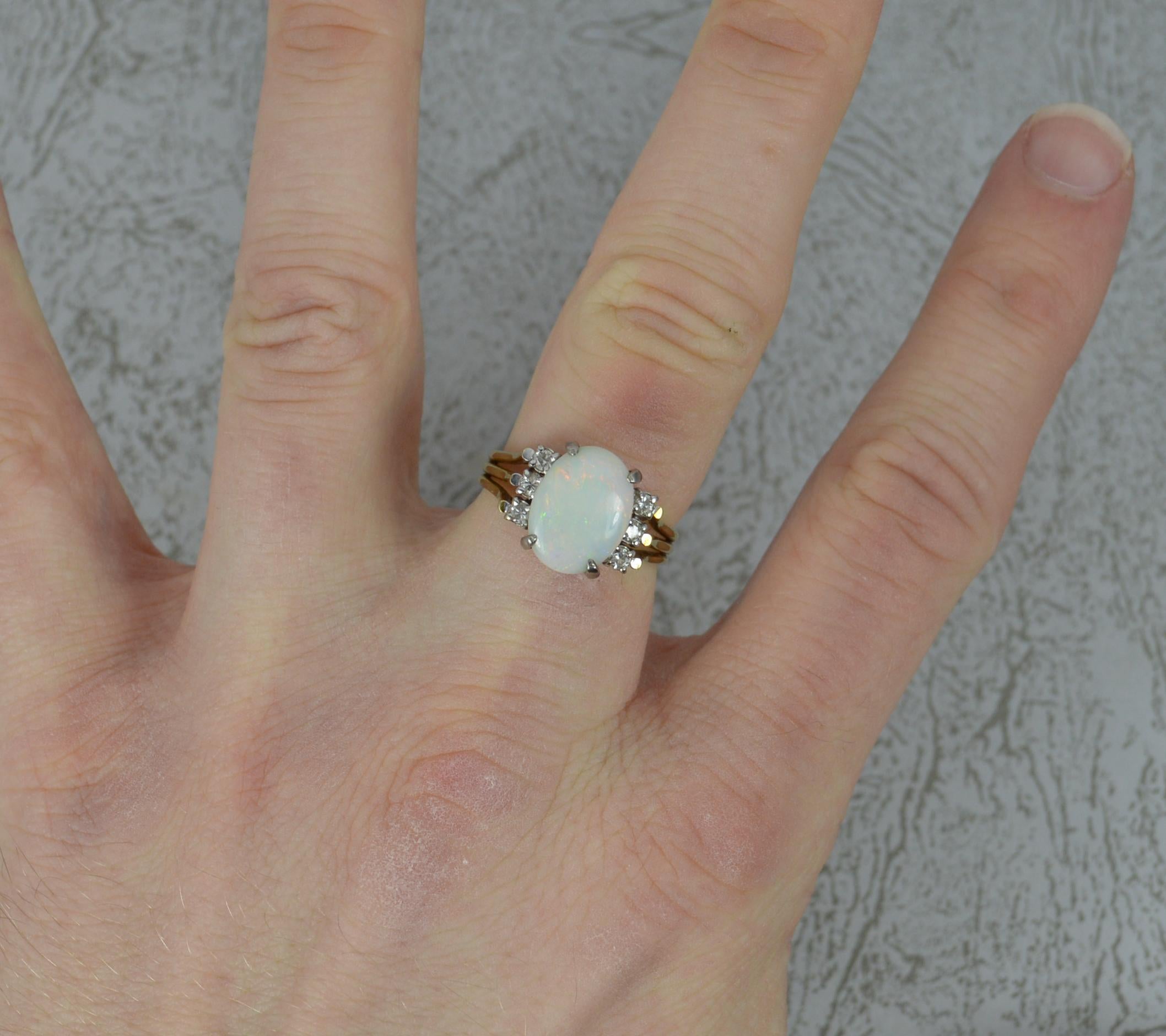 A fine quality opal and diamond 14ct gold ring.
Set with an oval opal to centre in four claw head. 11.5mm x 8.7mm with three round cut diamonds to each side.

Condition ; Very good. Clean, solid band. Well set stones. Issue free. Please view