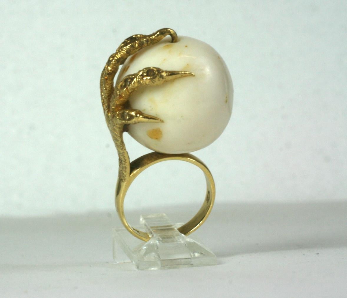 Amazing Coral Claw Ring from the 1970's with a massive white coral bead set in an 18k textured claw formed mount set with tiny diamond chips throughout.  Size 6. Bead 20mm. 1970's Italy. 
DOMESTIC SALES ONLY.