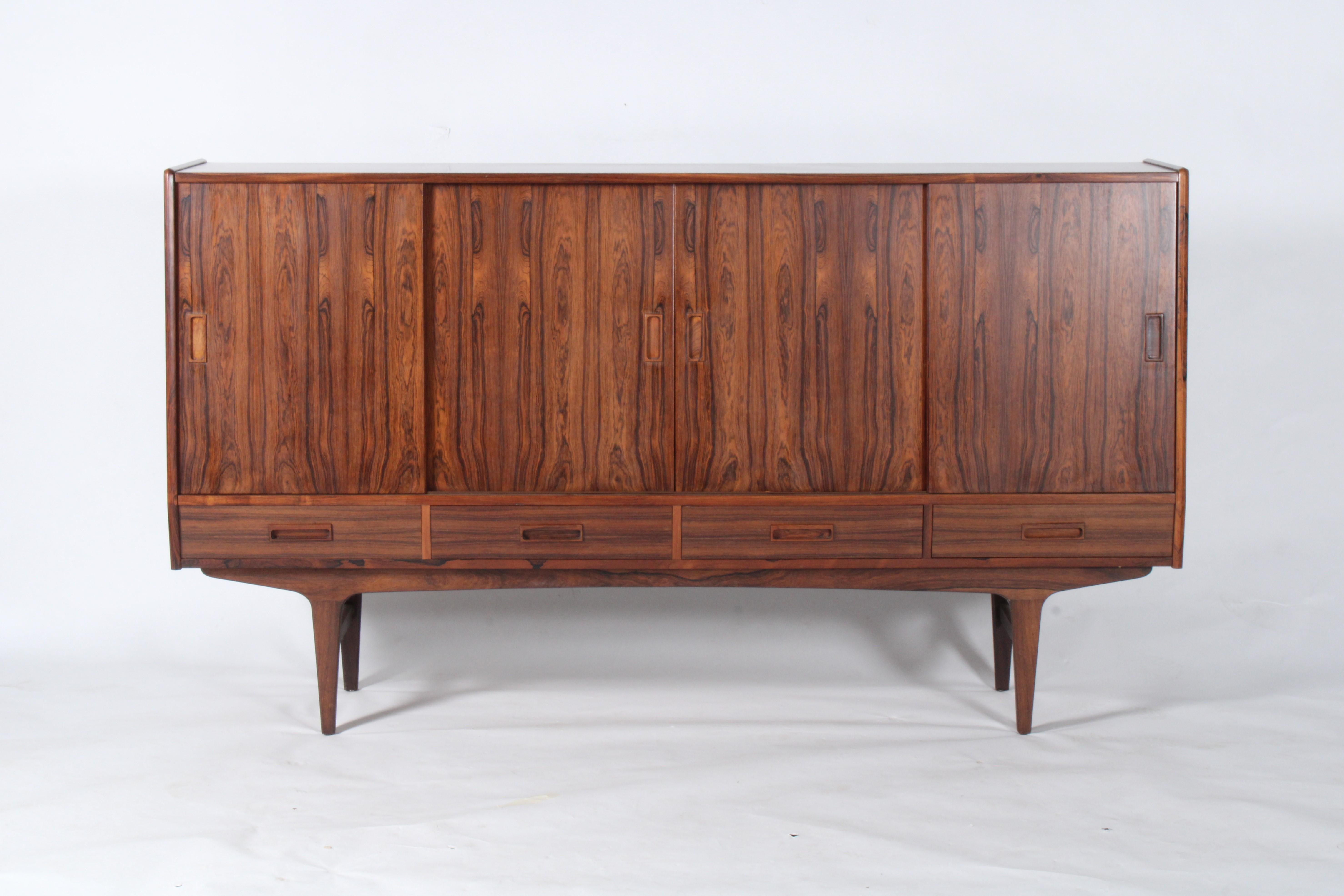 Dating from the 1960’s this stunning piece created in the 1960’s by Borge Seindal for P. Westergaard Mobelfabrik is constructed from the most striking rosewood. It has sliding doors behind which there is ample storage in the form of shelves and