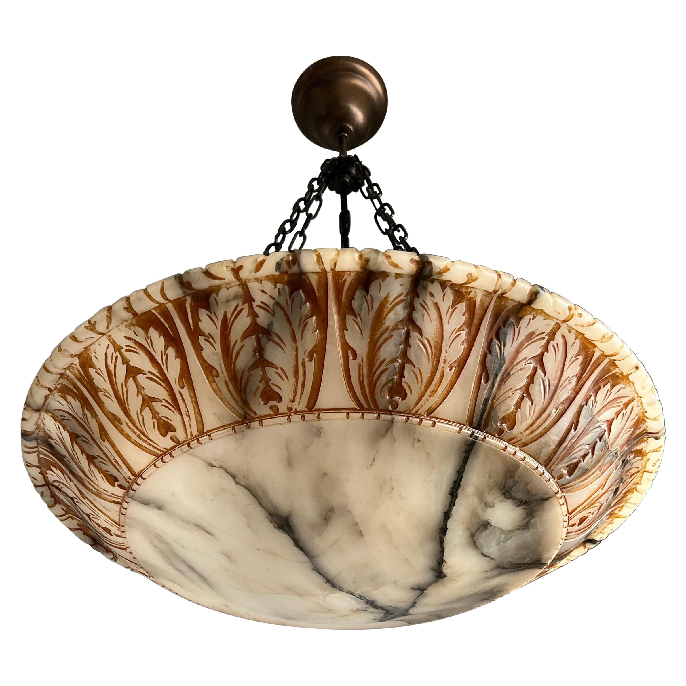 Remarkable size and unique design, hand carved, antique marble-like alabaster pendant light.

Thanks to its very large size & deep shade this remarkable alabaster chandelier is another one of our recent great finds that will light up both your days