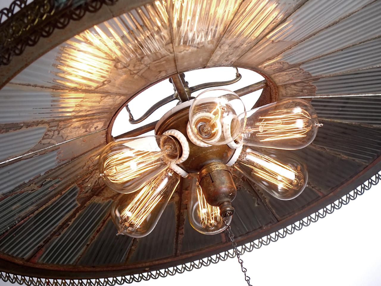 I've been doing this a while and in all the years I rarely get my hands on an example one like this. The mirrored ring of reflectors has a 35 inch diameter. All the original mirrors are there with no replacements and a wonderful rustic patina. The