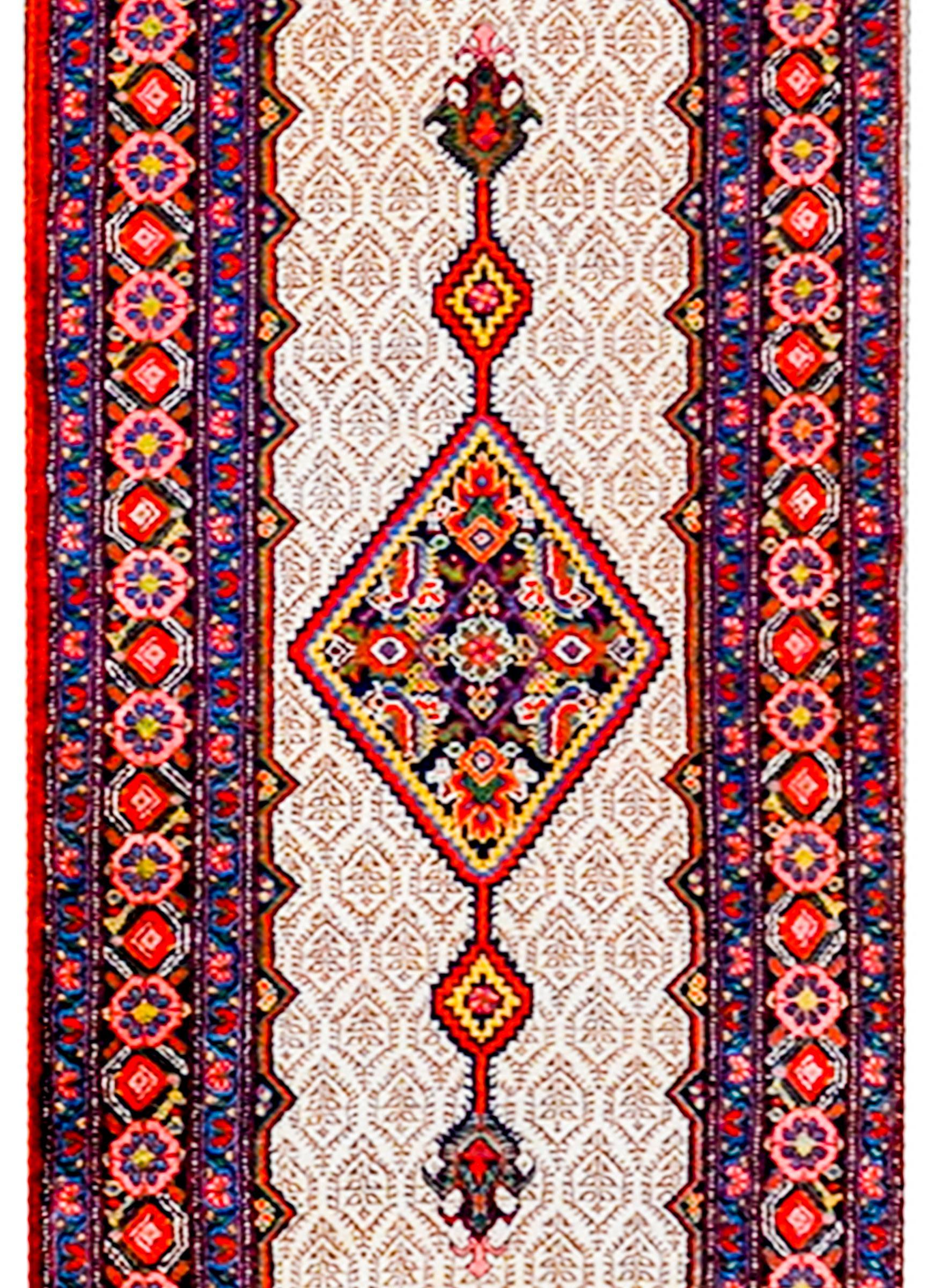 An amazing early 20th century Persian Serab runner with three large diamond medallions flanked by smaller diamond medallions amidst a camel-colored tone-on-tone petite floral patterned field. The border is wonderful with a beautiful large-scale