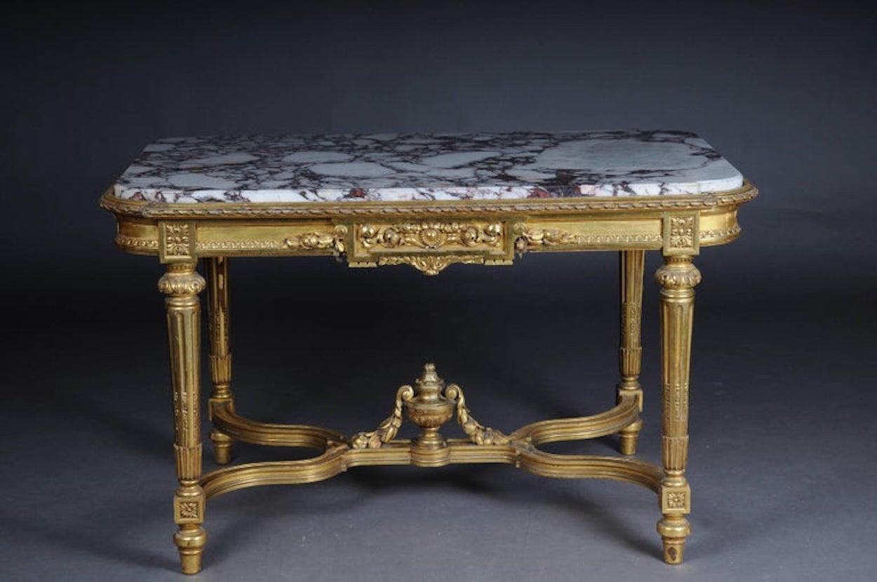 Amazing French Louis XVI Salon table gilded, around 1910

Solid wood oak, carved and gold leaf. The table is finely carved down to the last detail. On conical, fluted, carved legs, connected with X-shaped, heavily carved gutter.
On the cover plate