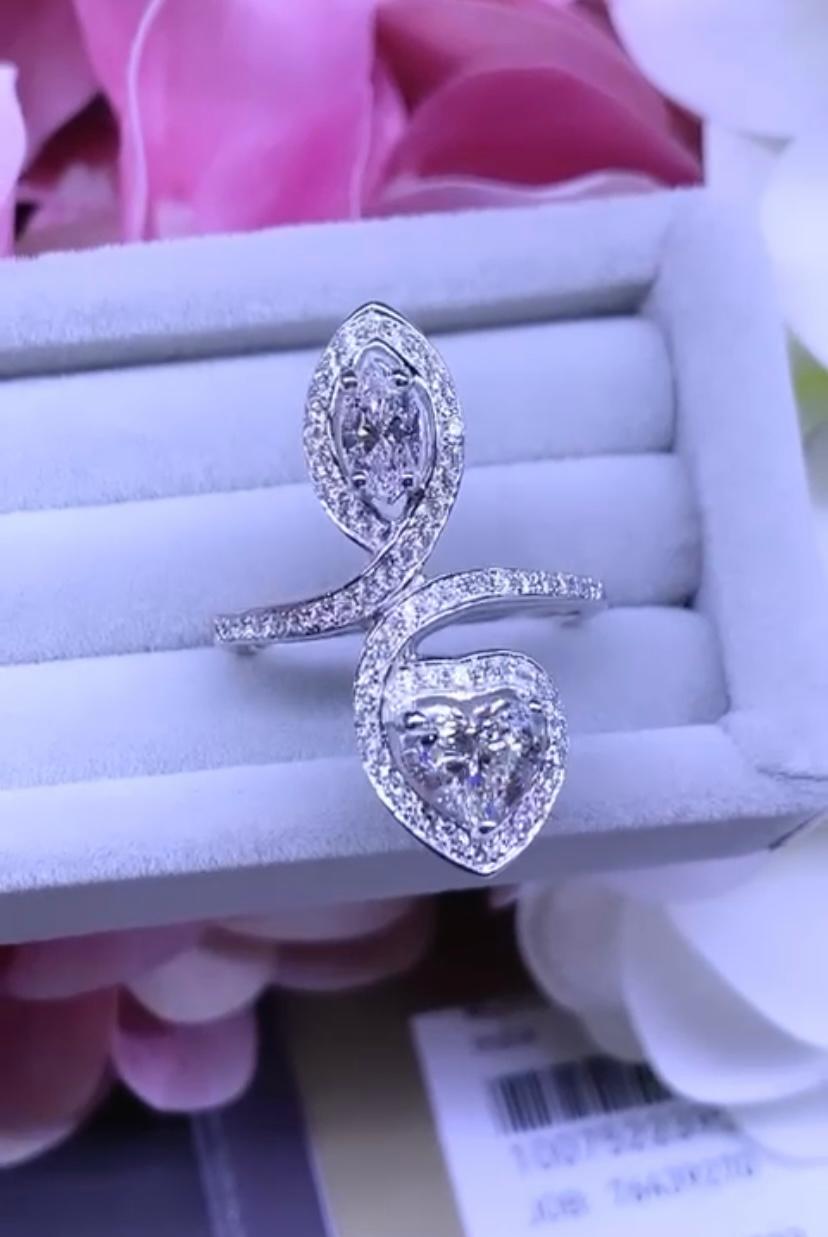 An exquisite design , so chic and elegant, perfect for all events. Ring is in 18k gold , with a GIA certified natural diamond, heart cut , of 1.01 carats, I  color/ VS2 clarity , and a GIA certified natural diamond, marquise cut, of 0.40 carats, D