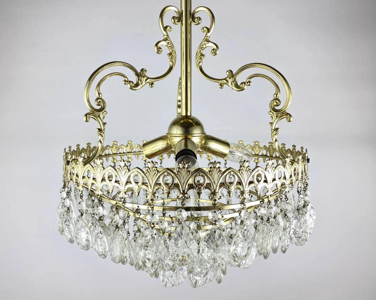 Circa 1970s Classic Style Chandelier with three light bulbs. 

 Richly fecorated chandelier's framework is in gilt brass, surrounded by 100 % profusion of transparent cut glass decorations that capture and reflect the light of the bulbs.

 This kind
