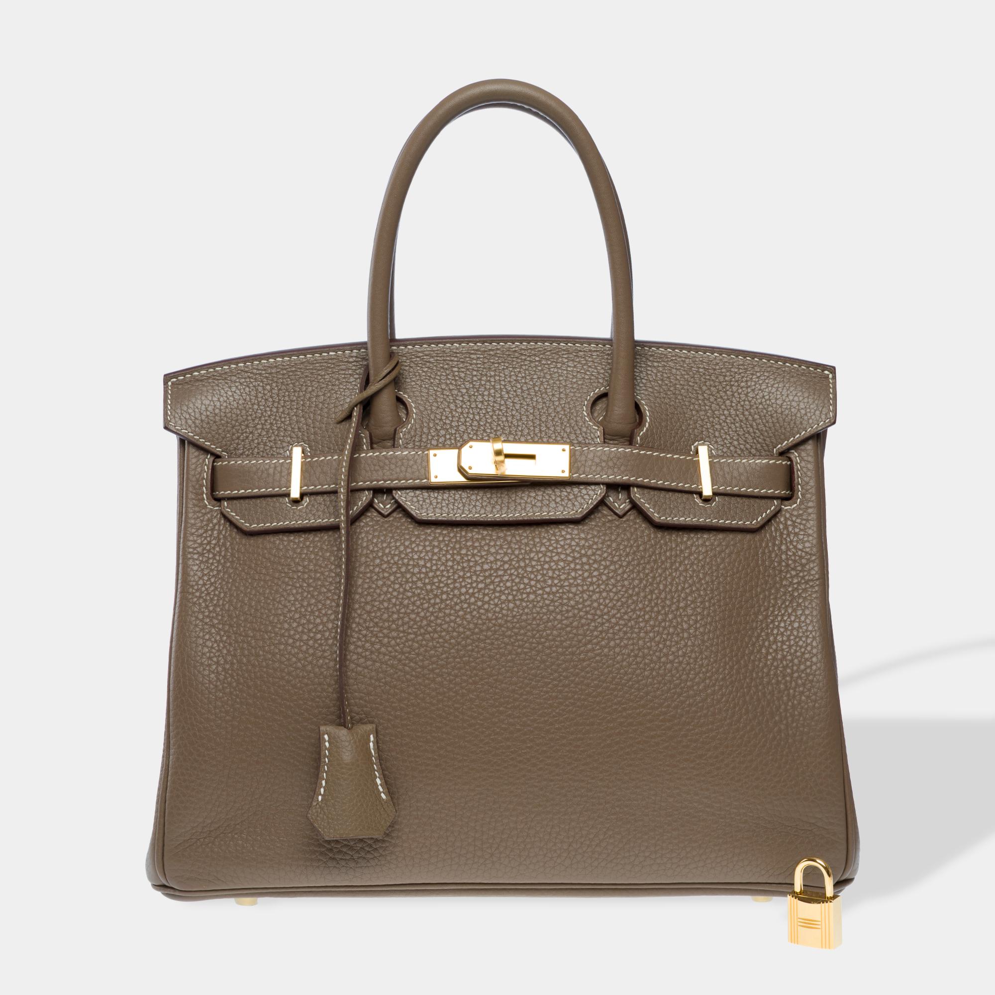 Exceptional​ ​and​ ​rare​ ​Hermes​ ​Birkin​ ​30​ ​handbag​ ​in​ ​Togo​ ​leather​ ​with​ ​white​ ​stitching,​ ​gold​ ​metal​ ​trim,​ ​double​ ​handle​ ​in​ ​Togo​ ​leather​ ​allowing​ ​it​ ​to​ ​be​ ​carried​ ​by​ ​hand

Flap​ ​closure
Lining​ ​in​