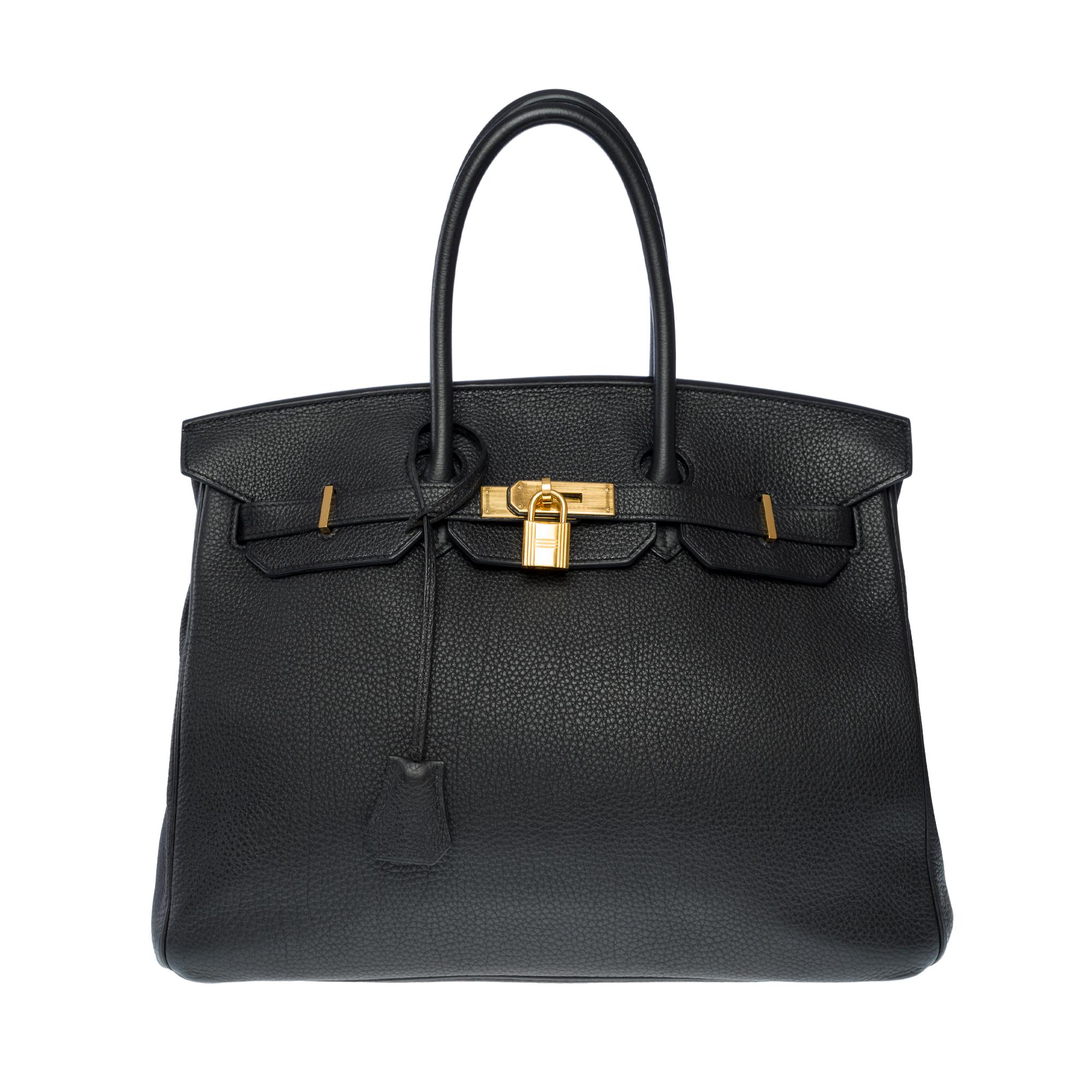 Stunning​ ​Birkin​ ​35​ ​handbag​ ​in​ ​black​ ​Togo​ ​leather​ ​with​ ​gold-plated​ ​hardware,​ ​double​ ​black​ ​leather​ ​handles​ ​for​ ​hand​ ​carry

Flap​ ​closure
Black​ ​leather​ ​interior​ ​with​ ​one​ ​zipped​ ​pocket​ ​and​ ​one​ ​slip​