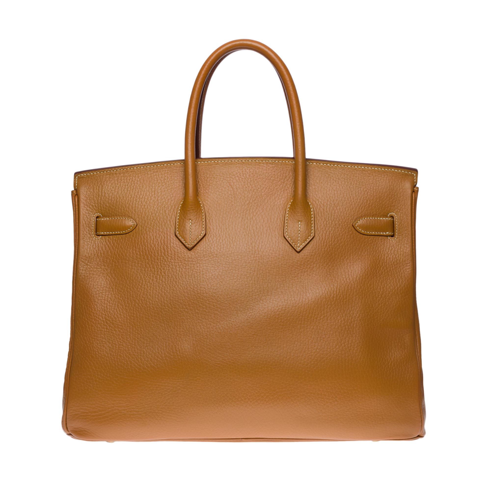 Splendid and very Rare Birkin 35 handbag in Gold Vache Ardennes leather (one of the most beautiful and sought after leathers of the house Hermès) , gold plated metal hardware, double handle in gold leather allowing a hand-held

Flap closure
Inner