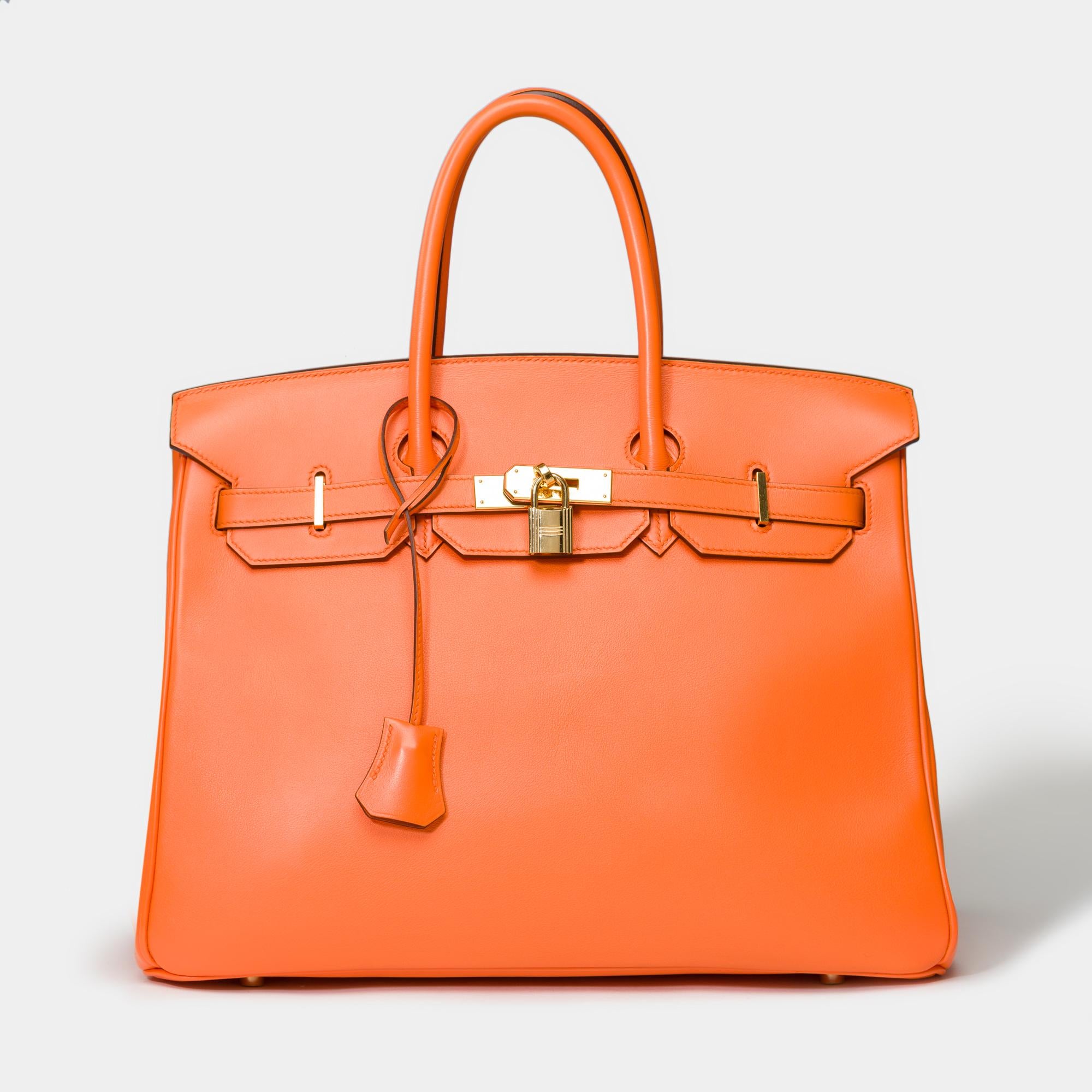 Amazing​​​ ​​​Birkin​​​ ​​​35​​​ ​​​handbag​​​ ​​​in​​​ ​​Orange​ ​​Swift​ ​calf​​ ​​​leather​​​ ​​​,​​​ ​​​gold-plated​​​ ​​​metal​​​ ​​​trim,​​​ ​​​double​​​ ​​​handle​​​ ​​in​​ ​​orange​​ ​​​for​​​ ​​​a​​ ​​hand​​​ ​​​Carry

Flap​​​
