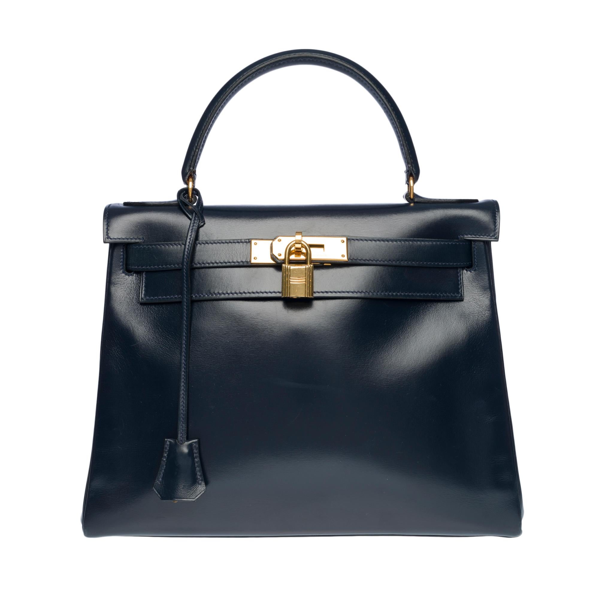 Exceptional Hermes Kelly 28 retourne handbag with double shoulder straps (classic navy blue box leather shoulder strap and navy blue canvas sport shoulder strap), gold plated metal hardware, simple navy blue box leather handle allowing a hand or