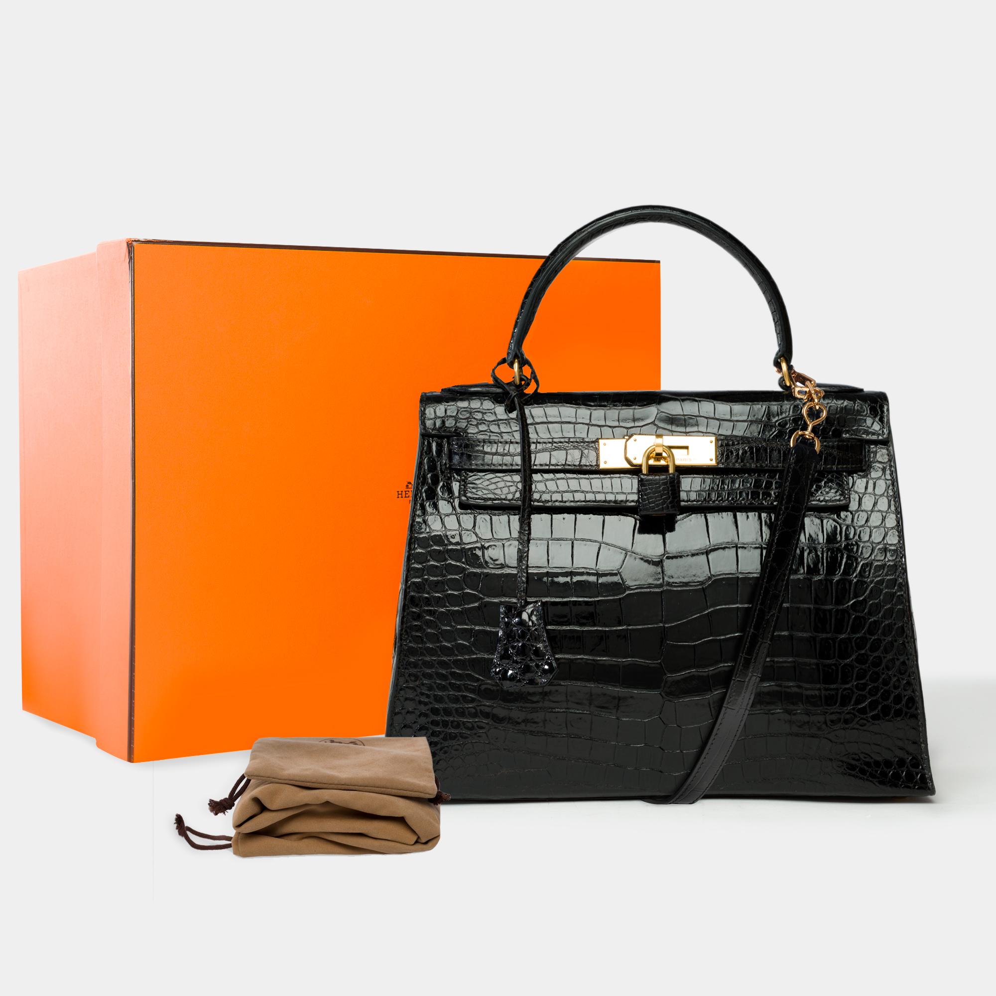 Exceptional​ ​Hermès​ ​Kelly​ ​28​ ​Sellier​ ​Bag​ ​in​ ​black​ ​Porosus​ ​crocodile,​ ​a​ ​removable​ ​black​ ​Porosus​ ​crocodile​ ​shoulder​ ​strap​ ​(unsigned​ ​made​ ​by​ ​a​ ​workshop​ ​and​ ​a​ ​Hermès​ ​former​ ​artisan),​ ​gold-plated​