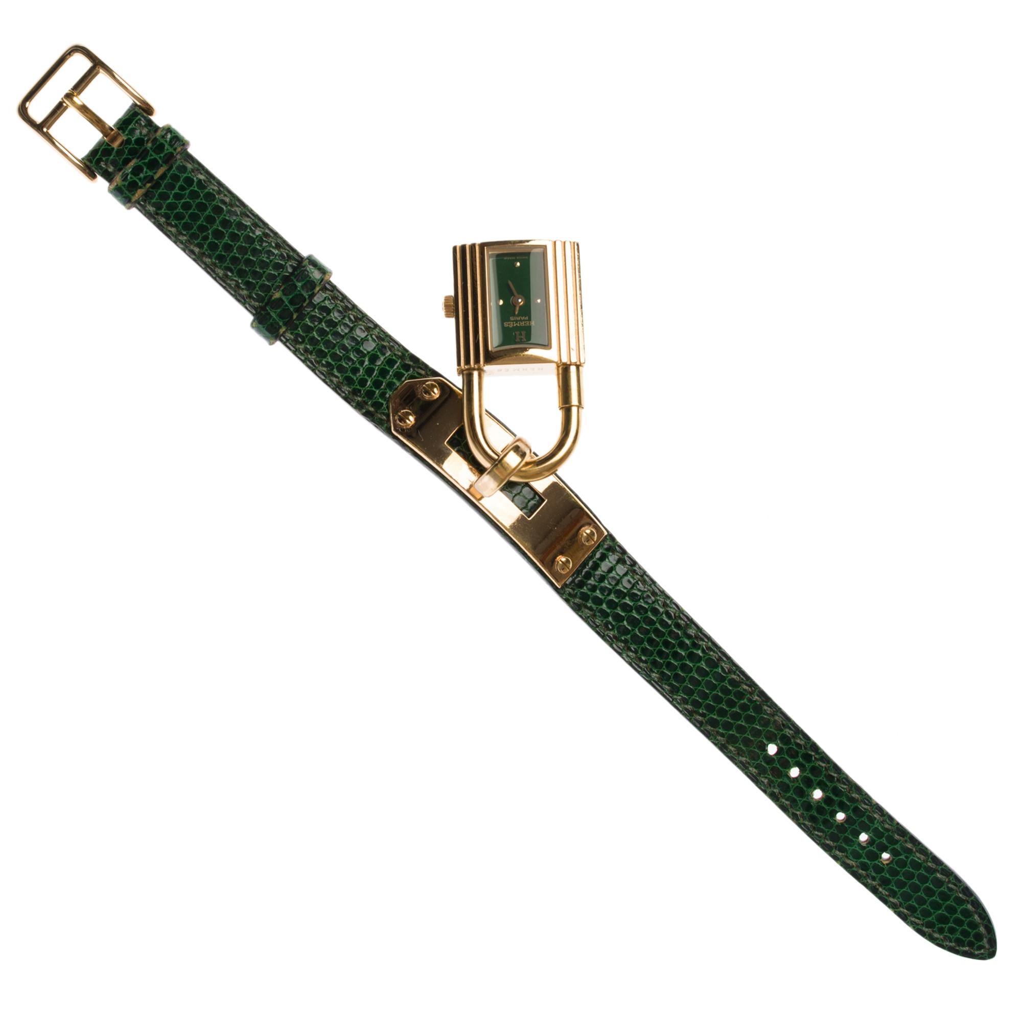 Hermes Kelly Gold Plated Padlock Bracelet Watch
Square case in gold plated with triple godrons, screwed bottom, fluted crown

Green dial, quartz movement
Applied indexes, straight gold-plated needles
Hermès Green Leather Bracelet, Hermès Gold Plated