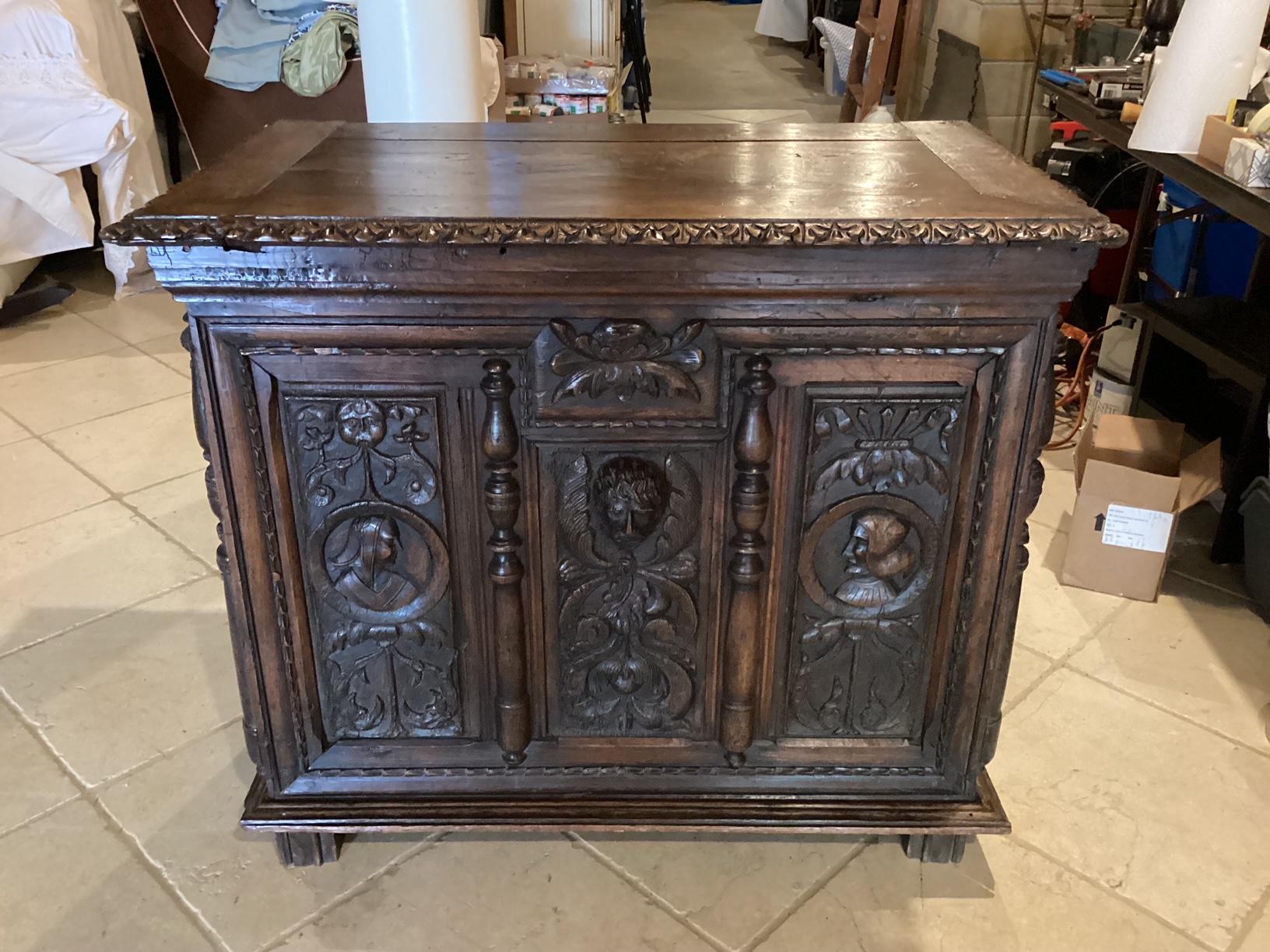 Gorgeous highly carved oak trunk featuring rich Renaissance figures with lots of floral and leaf motifs.  The top opens to reveal plenty of storage, while closed it may be used as a side table or as a seat in a mudroom or foyer. 