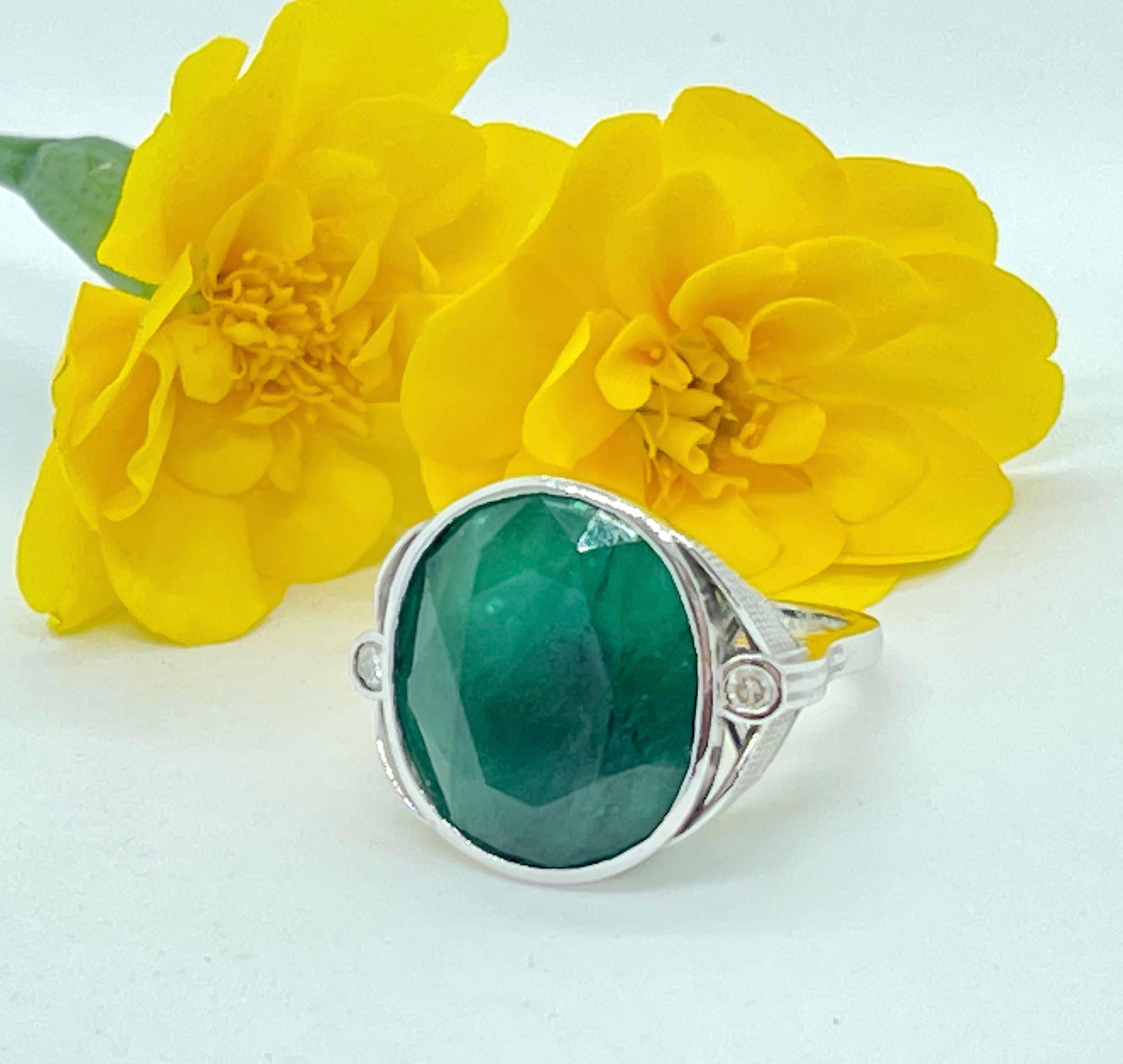 This Magnificent Ring features a HUGE Natural Emerald with Diamonds on the side.

The Emerald is medium-strong green and weighs approximately 20.82 carats  It has been classified as ‘medium dark’ because the stone has inclusions which make it