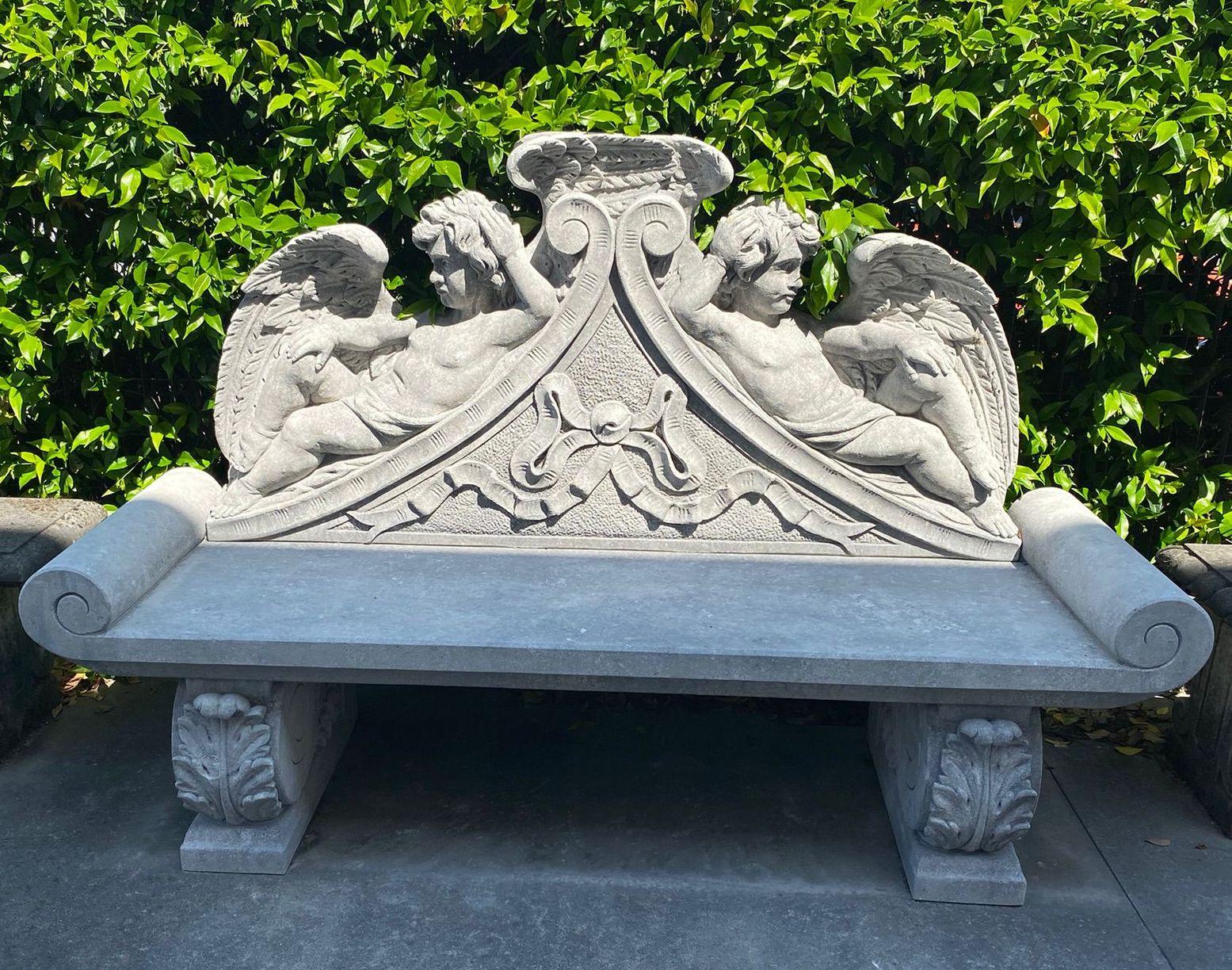 Exceptional Italian craftsmanship with stunning motifs of delicious winged Putti figures in limestone, 
 enriched with garland and leaves. 
Great decoration for Garden and Patio furniture.
 We can disassemble the bench and prepare the packaging