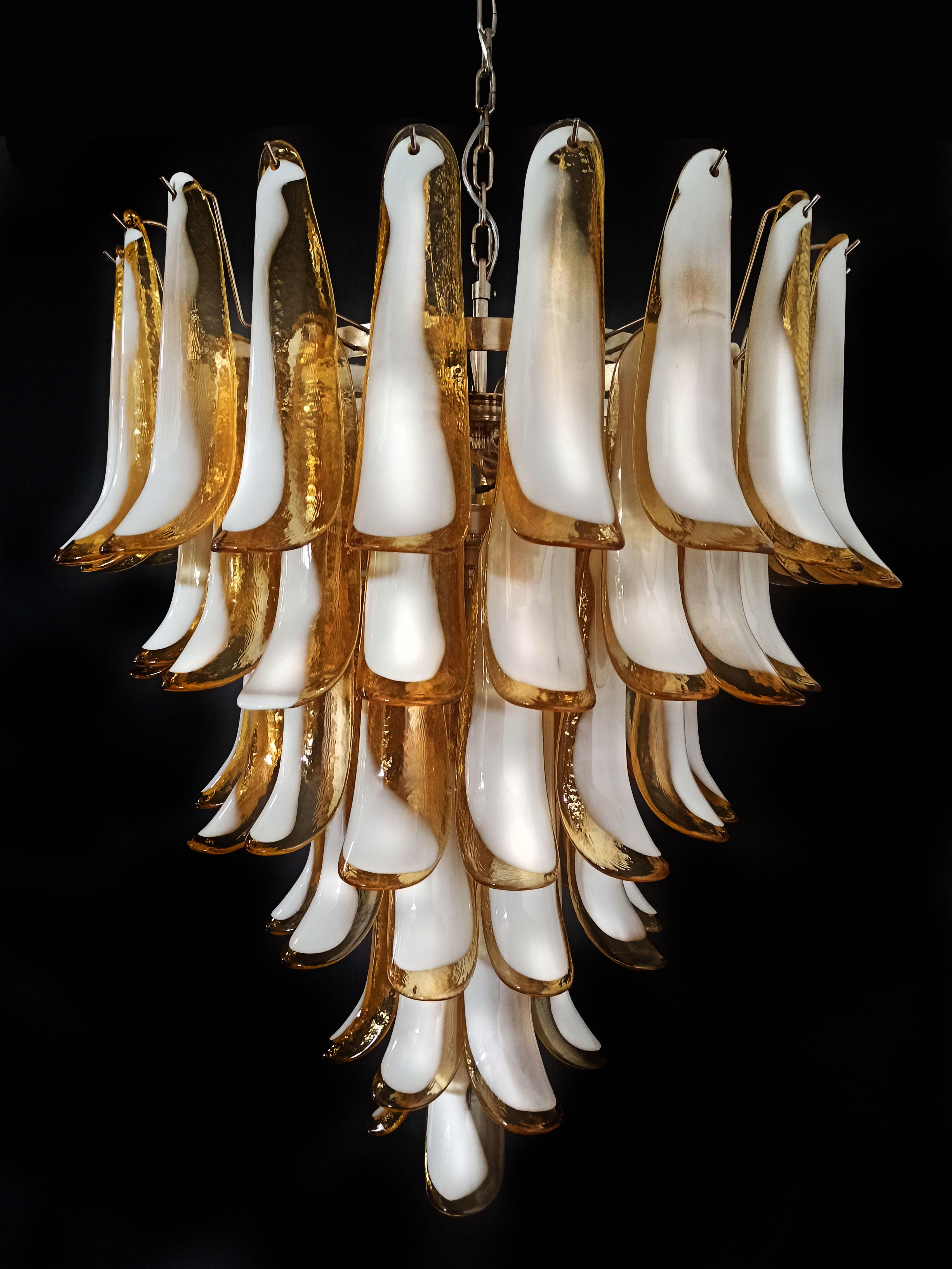 Hand blown glass chandelier composed by 75 glass amber petals in a chrome frame.
Dimensions: 65 inches (165 cm) height with chain, 37.40 inches (95 cm) height without chain, 31.50 inches (80 cm) diameter
Dimension glasses: 11.40 inches (29 cm)