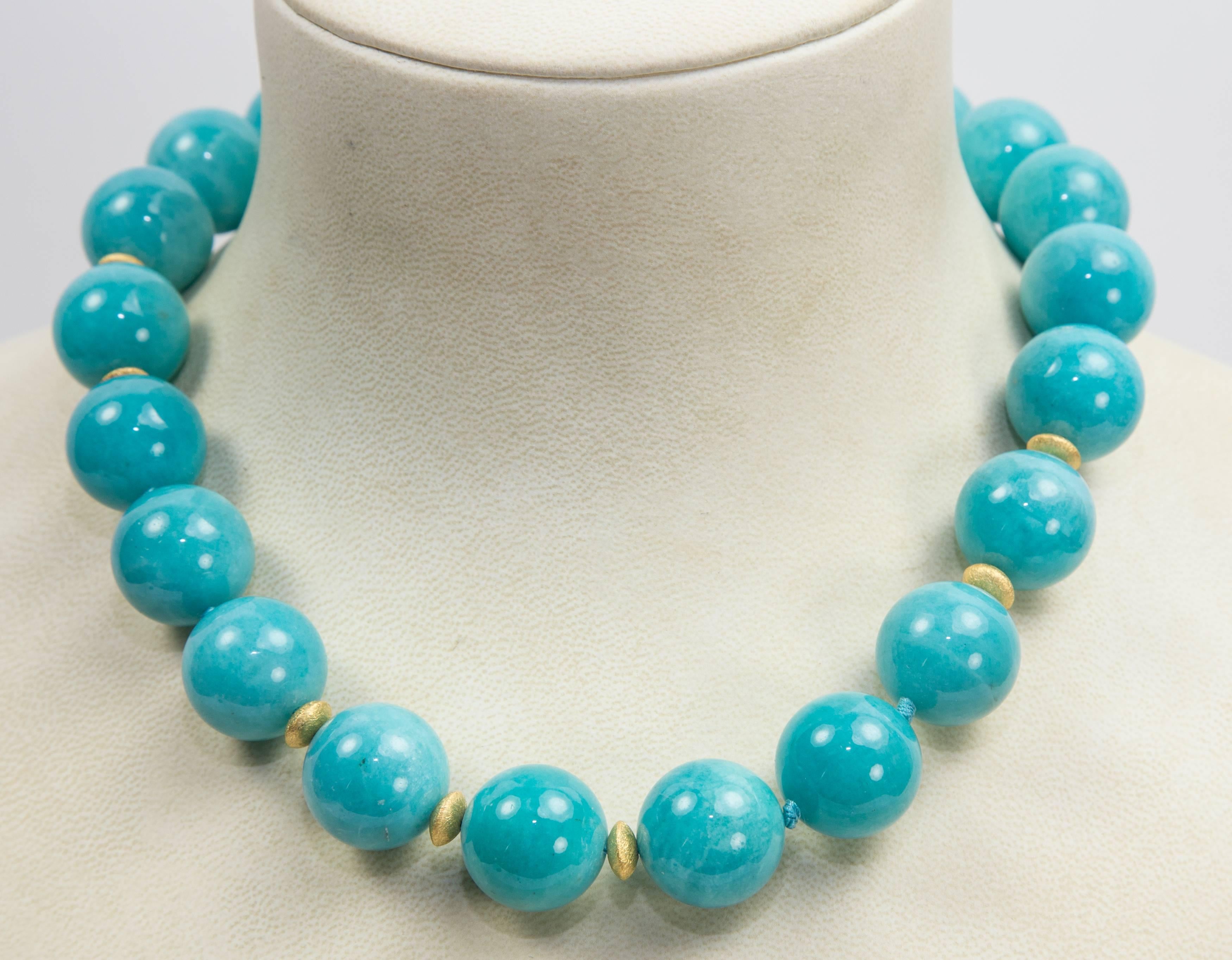 Stunning large Turquoise Blue Amazonite Natural Bead necklace enhanced by gilded sterling silver spacers. Hand knotted on matching blue thread and finished with a Gilded Sterling Silver circular clasp. Necklace measures approx. 19”. Spectacular in