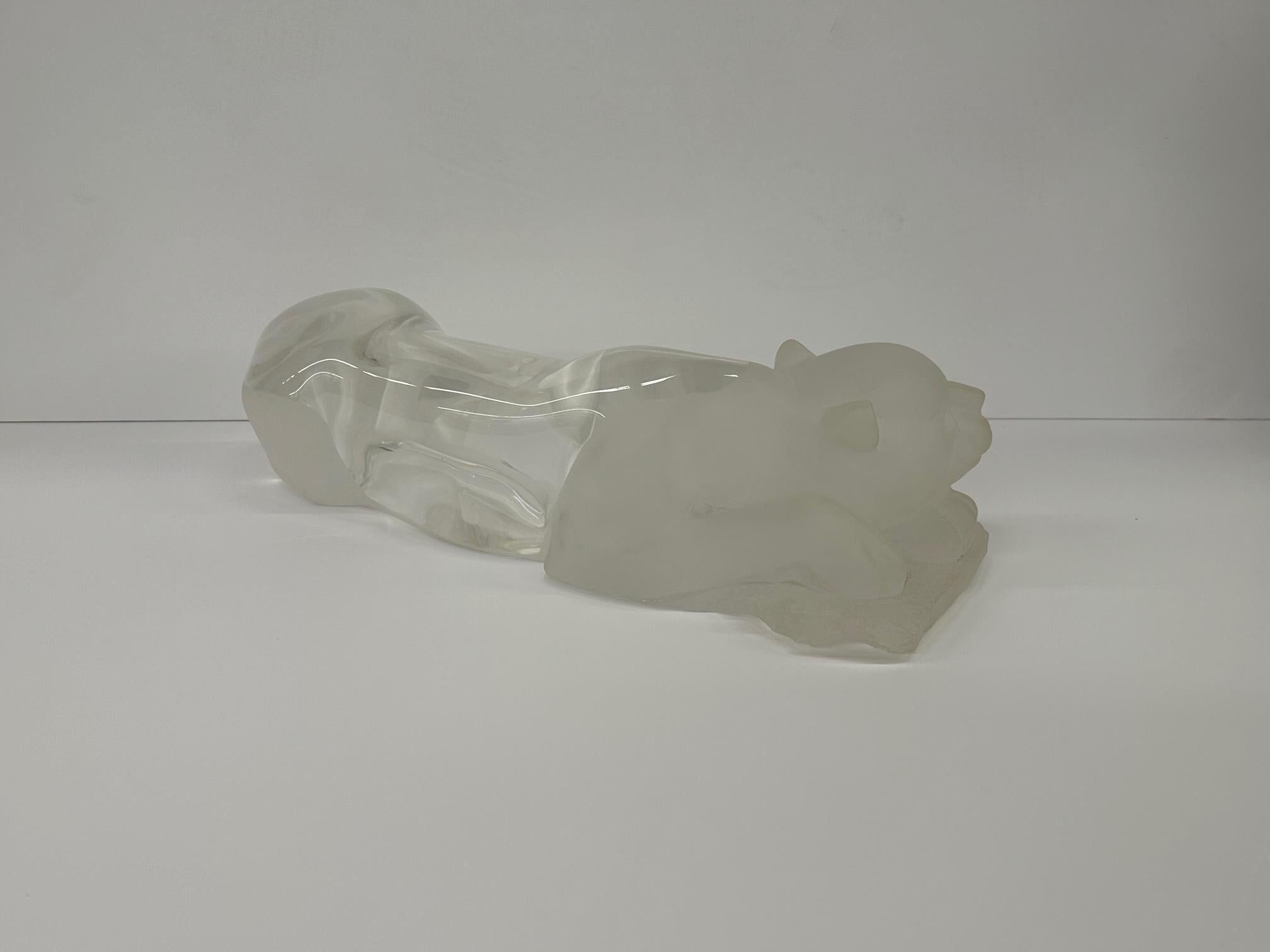 An enviably eye catching large supine panther stretched out in a sexy position and sculpted like ice, having a mouthwatering blend of frosted and clear lucite.