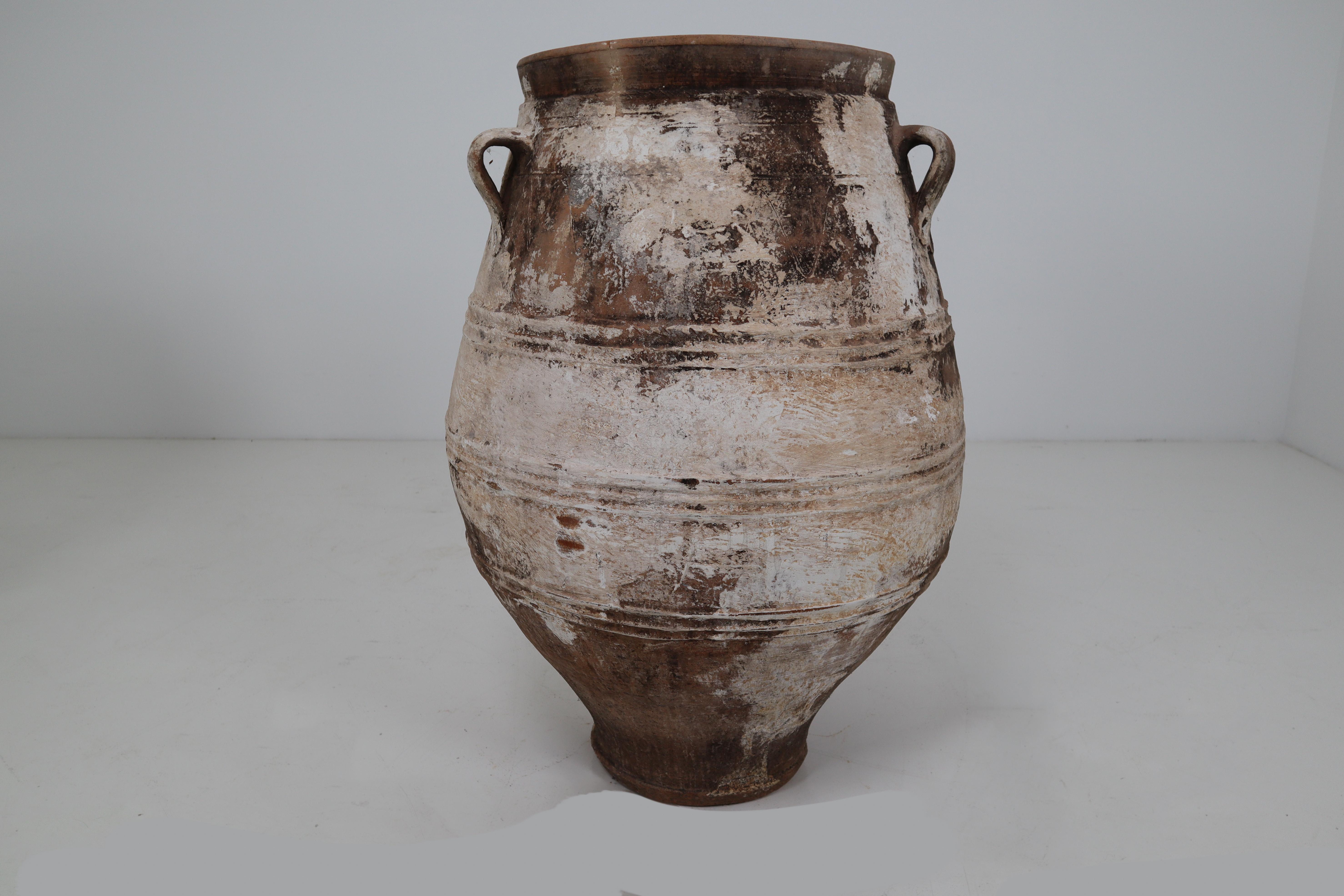 A large vintage three-handled painted terracotta urn from early 20th century Greece, with white finish and rounded belly. Picture this large 1900s urn in its former life, on a shaded terrace under an olive tree overlooking the Mediterranean Sea in