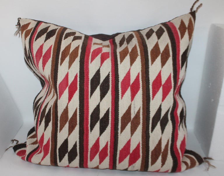 This fantastic saddle blanket has the original corner ties and the now large pillow has a dark chocolate brown linen backing. The insert is down and feather fill with a zipper closure. The condition is mint.
 