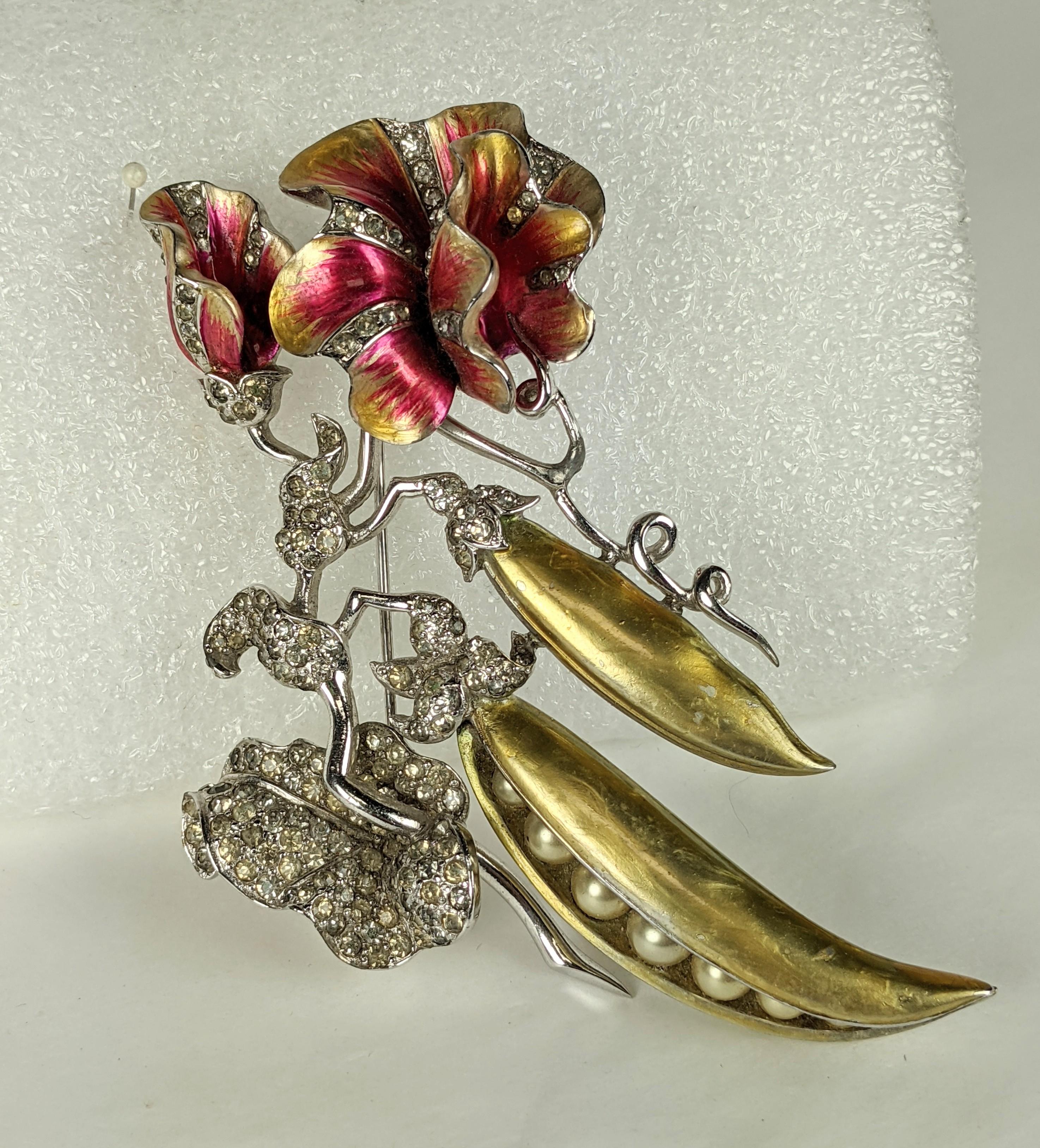 Massive and Rare Marcel Boucher Sweet Peapod brooch circa 1940. The large scale brooch of a sweet pea plants' branch in full bloom. Of rhodium plate base metal with crystal rhinestone pave accents. The flower heads and peapods adorned with signature