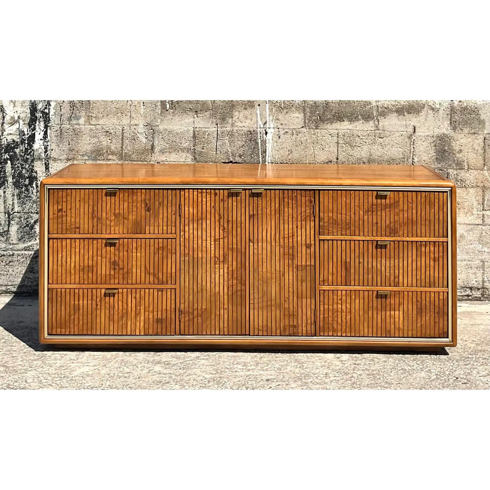 Fantastic vintage MCM credenza. Made by the iconic American Of Martinsville. Beautiful Burl wood cabinet with a chic ribbed detail on the drawer fronts. Two door reveal an additional three drawers. Acquired from a Palm Beach estate.