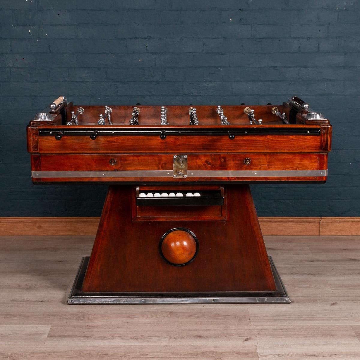 Beautiful and fully restored French table football game, mid-20th century. Painted and varnished wood and chromium plated and other metals, each side with four wooden-handled rods, and mounted with Art Deco style glass ashtrays, the footballers of