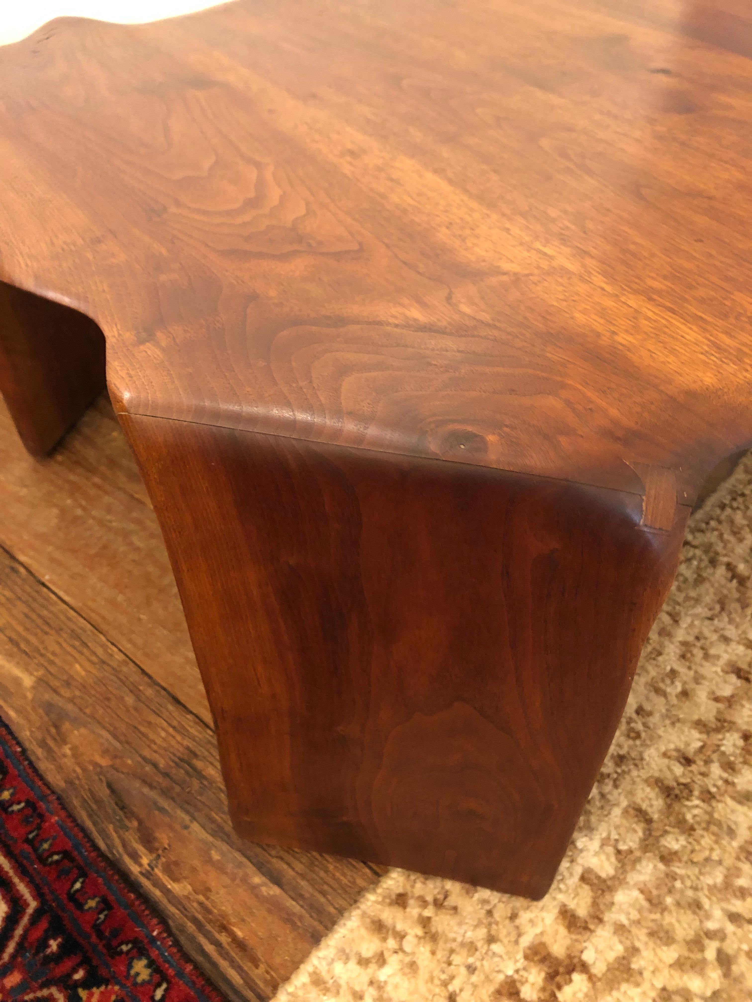 Beautiful artisan hand made one of a kind sculpted walnut coffee table having an irregular Nakashima inspired amoeba shape and elegant waterfall legs. Signed and dated on the bottom.