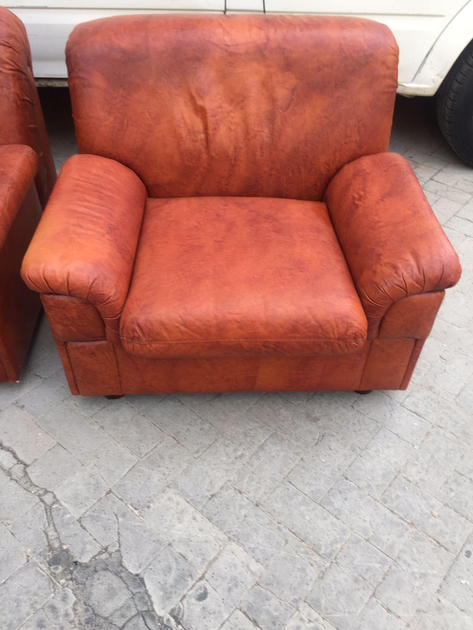 Amazing pair of armchairs in the style of Paolo Lomazzi. The armchairs are in original condition and are upholstered in brown leather. Fine Italian workmanship, beautiful shape and absolute comfort for the guest. Its large and soft cushions give its
