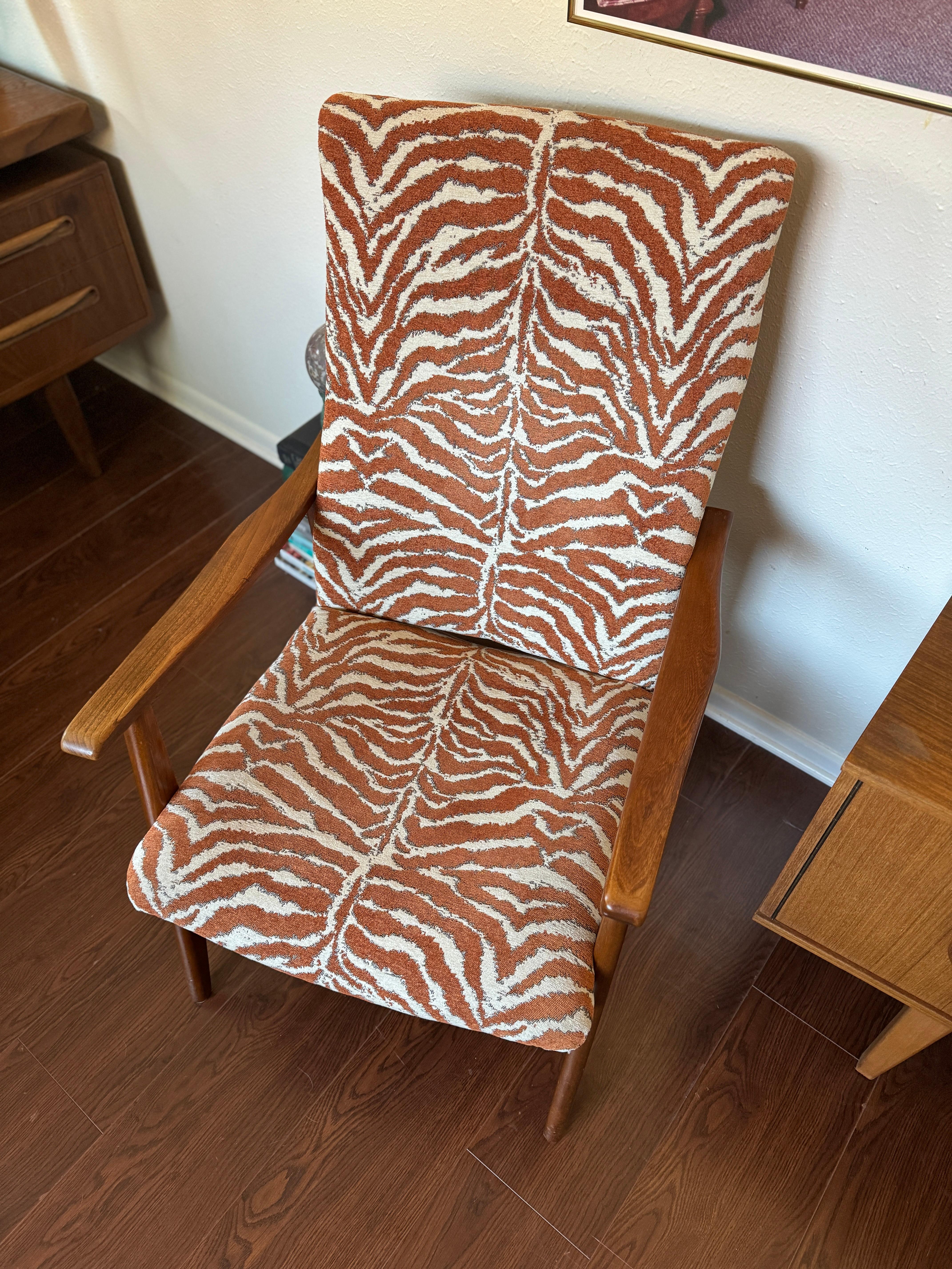 Amazing mid century modern Scandinavian style high back lounge chair, circa 1960s. Solid teak frame with a zebra like burnt orange and cream upholstery that’s in good condition. There’s a beautiful patina to the teak. Maker is unknown. 

22” W × 24”