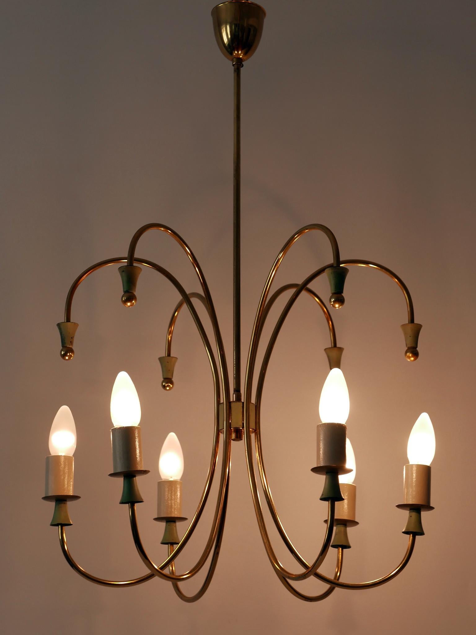 Exceptional six-armed Mid-Century Modern Sputnik chandelier or pendant lamp. Designed and manufactured in 1950s, Germany.

Executed in brass, the chandelier or pendant lamp needs 6 x E14 / E12 screw fit bulbs. It is rewired, works both with 110 /