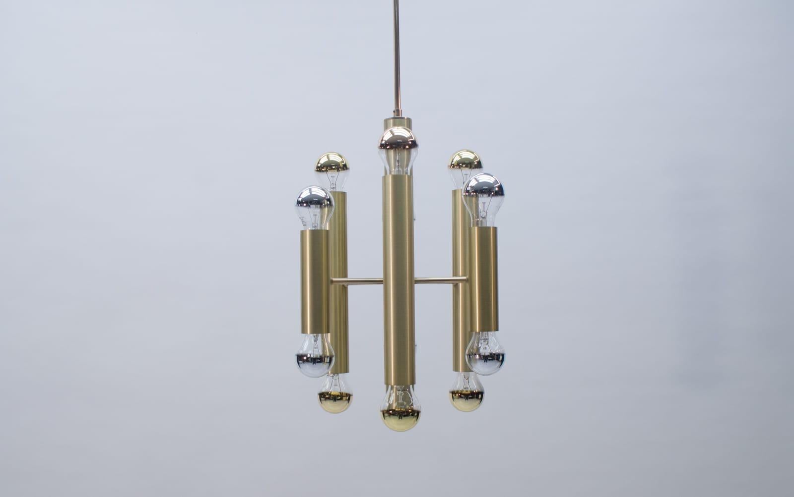 Gorgeous twelve-flamed Mid-Century Modern Sputnik chandelier or pendant lamp. Designed and manufactured in 1960s, Germany.

Executed in brass. The chandelier needs 12 x E27 screw fit bulbs. It works both with 110 / 230 volt.

Good original