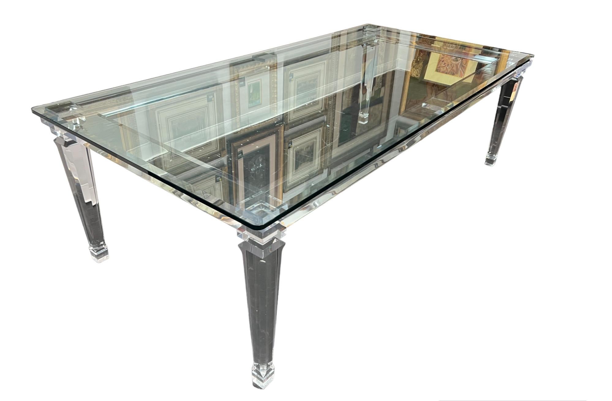This remarkable Lucite Table with a 5/8 inch thick beveled glass top, a stunning piece that seamlessly combines modern elegance with versatility. This table is a true statement of contemporary design and craftsmanship, guaranteed to elevate any