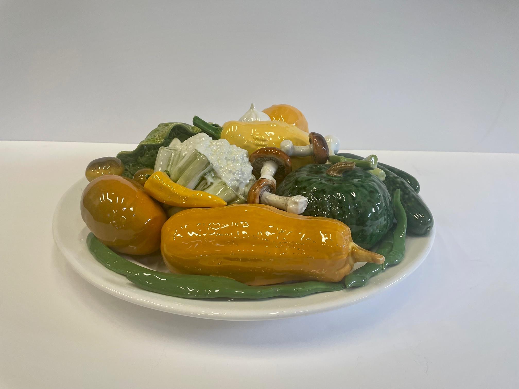 A work of art Italian glazed ceramic charger plate in monumental scale with mouthwatering display of better than life like vegetables.