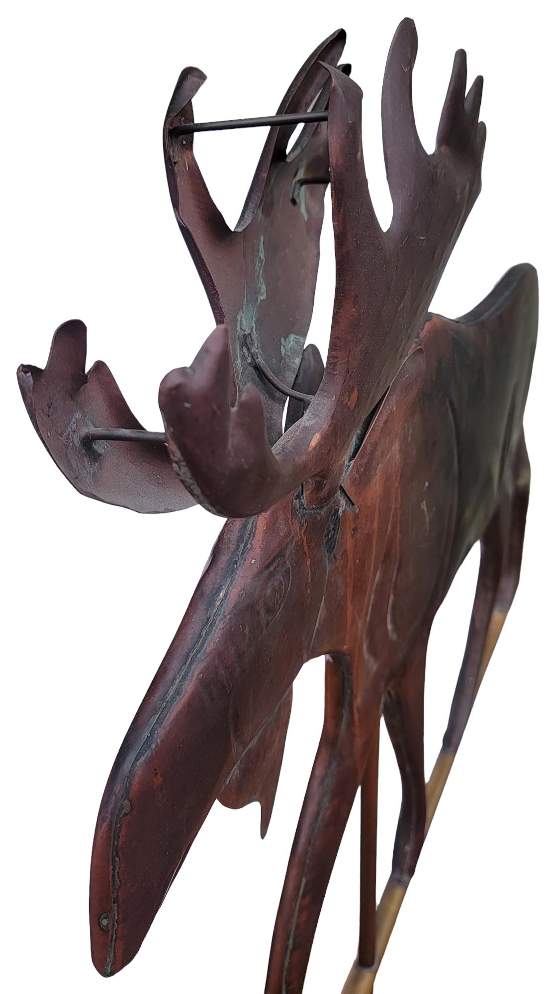 This fun piece of folk art is amazing and quite whimsical moose weather vane on a custom made iron mount.The moose is made from copper and retains a wonderful aged patina.