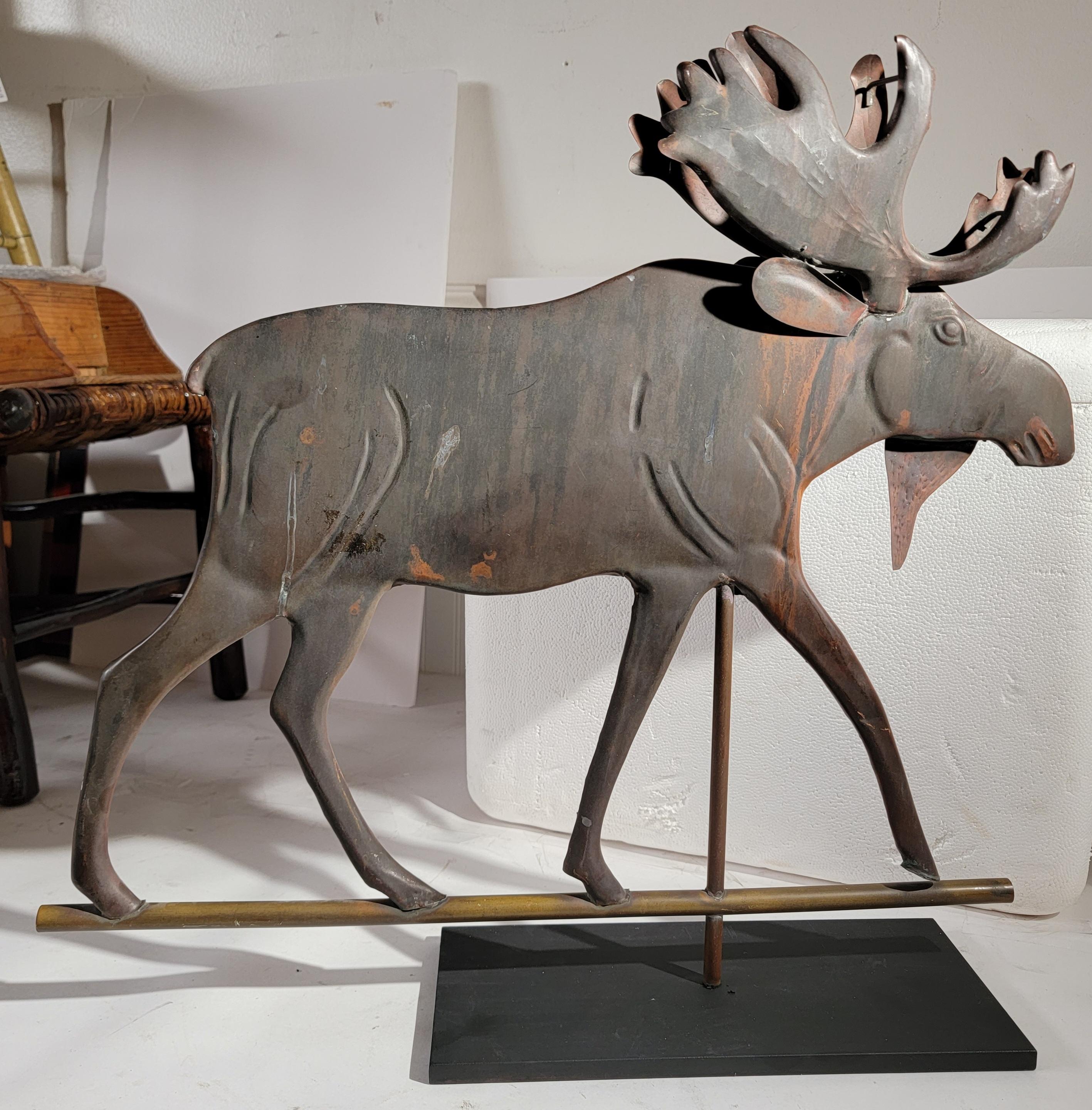 This fun piece of Folk Art is amazing and quite whimsical moose weather vane on a custom made iron mount.The moose is made from copper and retains a wonderful aged patina.