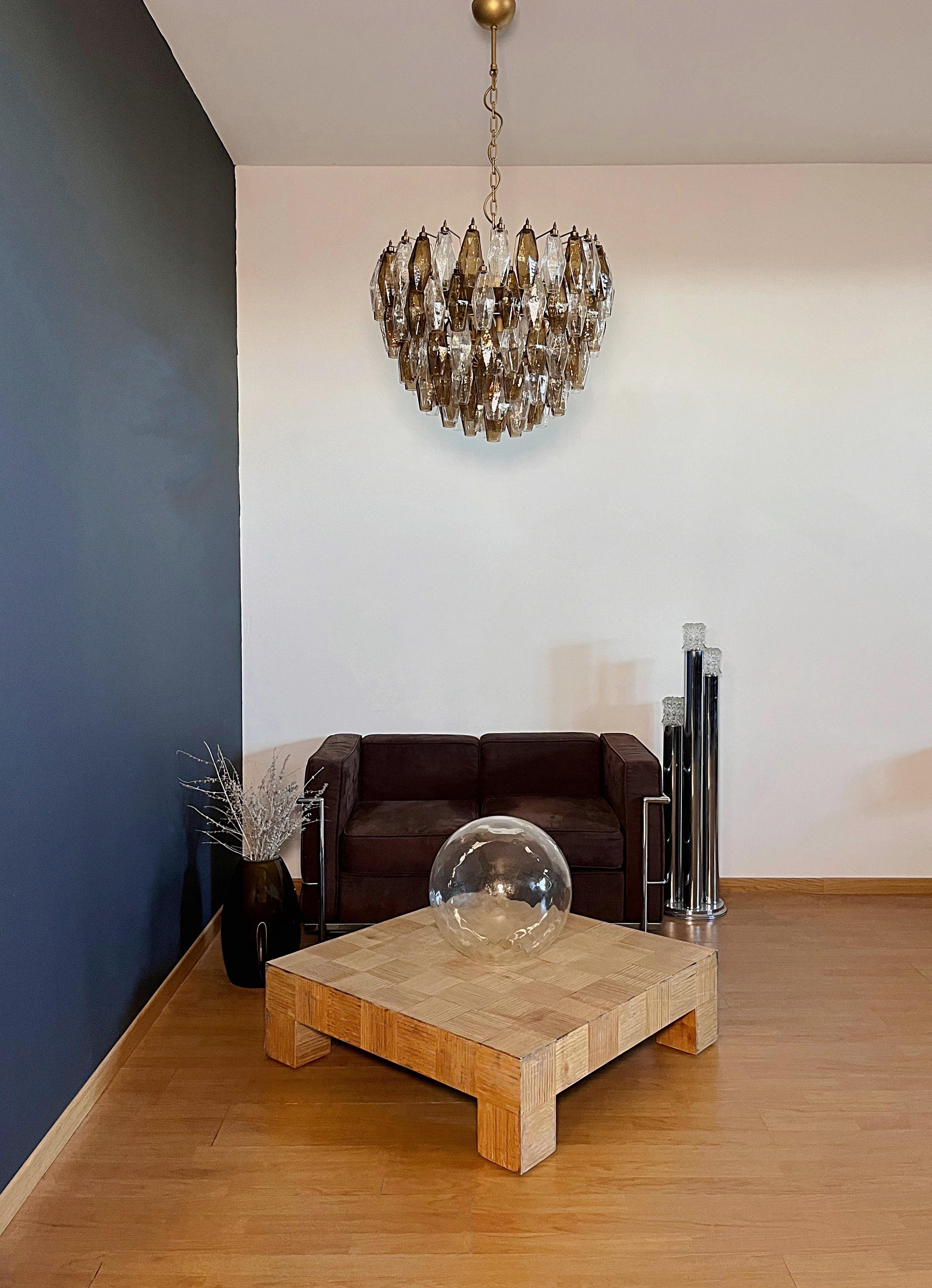 It sounds like you have a stunning piece of art with that Italian pendant light! The combination of 111 smoked and clear Murano glasses and a gold and brass structure creates a truly elegant aesthetic. 
Weight of chandelier about 28 kg.
Period: late