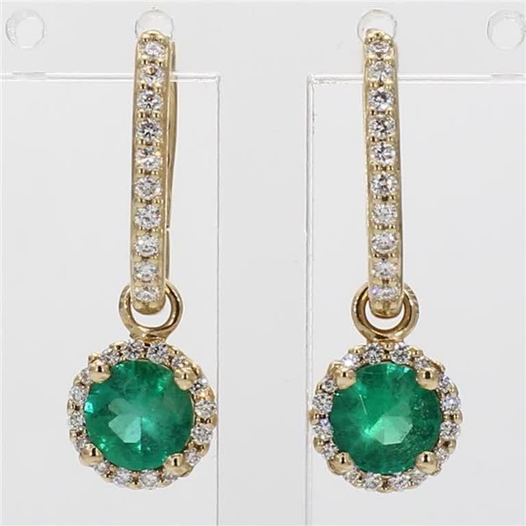 RareGemWorld's classic natural round cut emerald earrings. Mounted in a beautiful 14K Yellow Gold setting with natural round cut green emerald's. The emerald's are surrounded by a single halo of natural round white diamond melee as well as diamonds