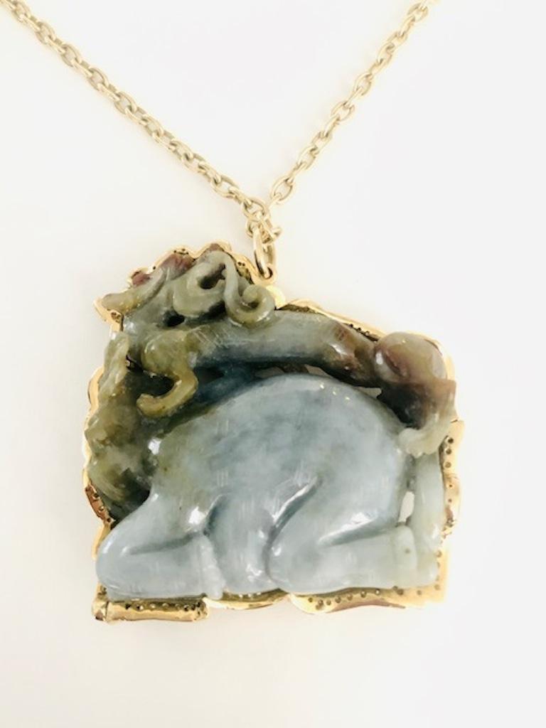 This amazing carved Jade depicts a Fire Dragon on the back of a crouching Elephant, the Jade is from a collection over 50 years old, I designed and made totally by hand the frame for the Jade and handmade the 18 Kt Gold Chain. This is a serious