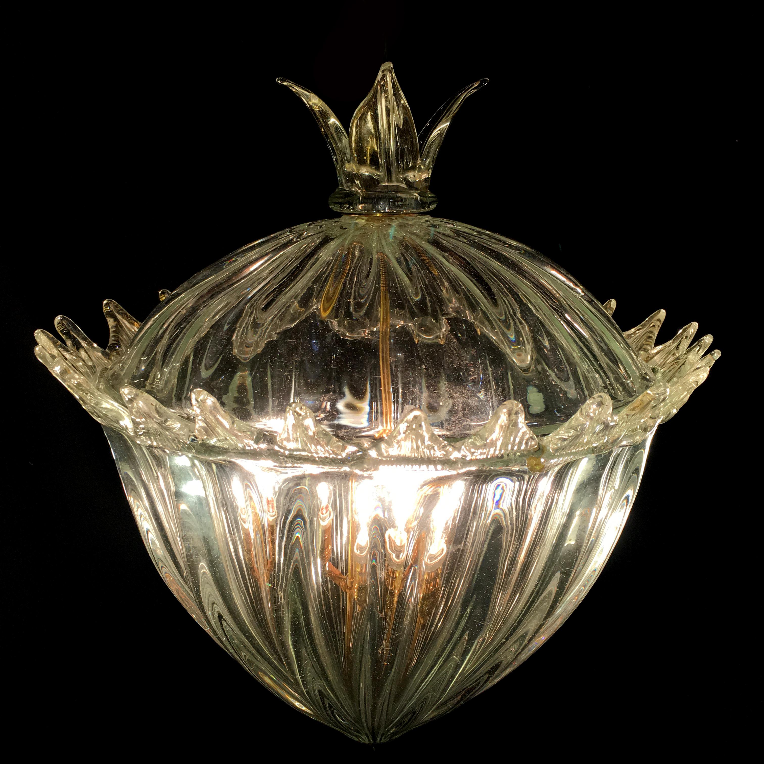 Piece of incredible beauty in massive Murano glass with inclusions of gold. The pair is made up of two equal chandeliers, one has a diameter of 42 cm and the other of 46 cm. The height of both is 100 cm. They can also be purchased individually.