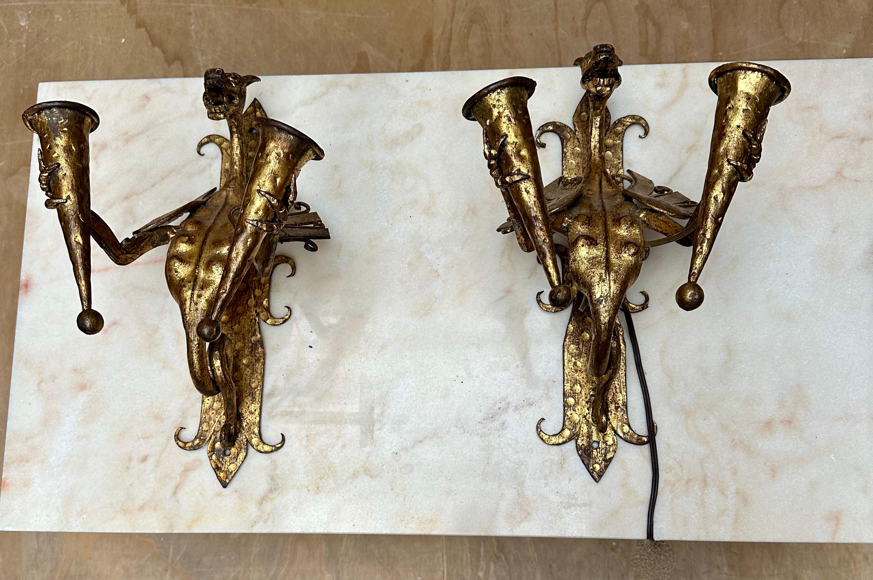 Gothic Revival pair of sculptural and highly decorative, wrought iron torchiere holders wall lamps.

If you appreciate decorative antiques in general and you are looking for a pair of large Medieval style wall fixtures in particular then this rare