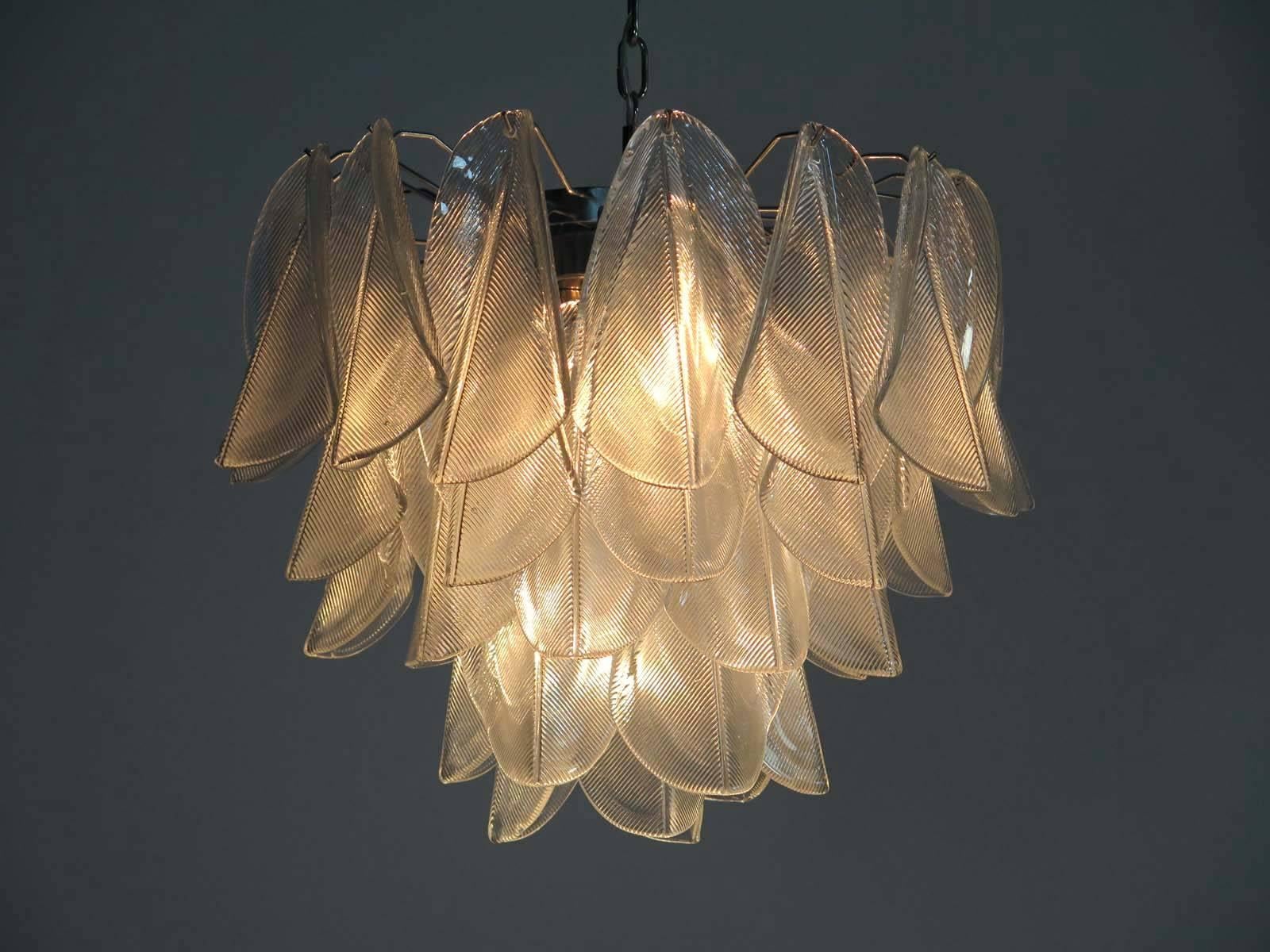 Pair Italian vintage Murano chandeliers. Each fixture is made up of 41 individual hand blown transparent glass elements hanging from a chrome frame.
Dimensions: 49.20 inches (125 cm) height with chain, 21.65 inches (55 cm) height without chain,