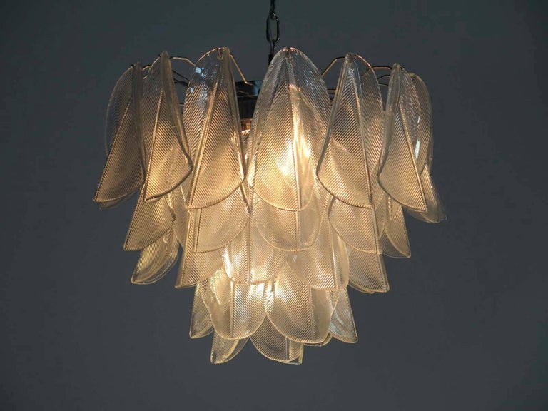Pair Italian vintage Murano chandeliers. Each fixture is made up of 41 individual hand blown transparent glass elements hanging from a chrome frame.
Dimensions: 49.20 inches (125 cm) height with chain, 21.65 inches (55 cm) height without chain,