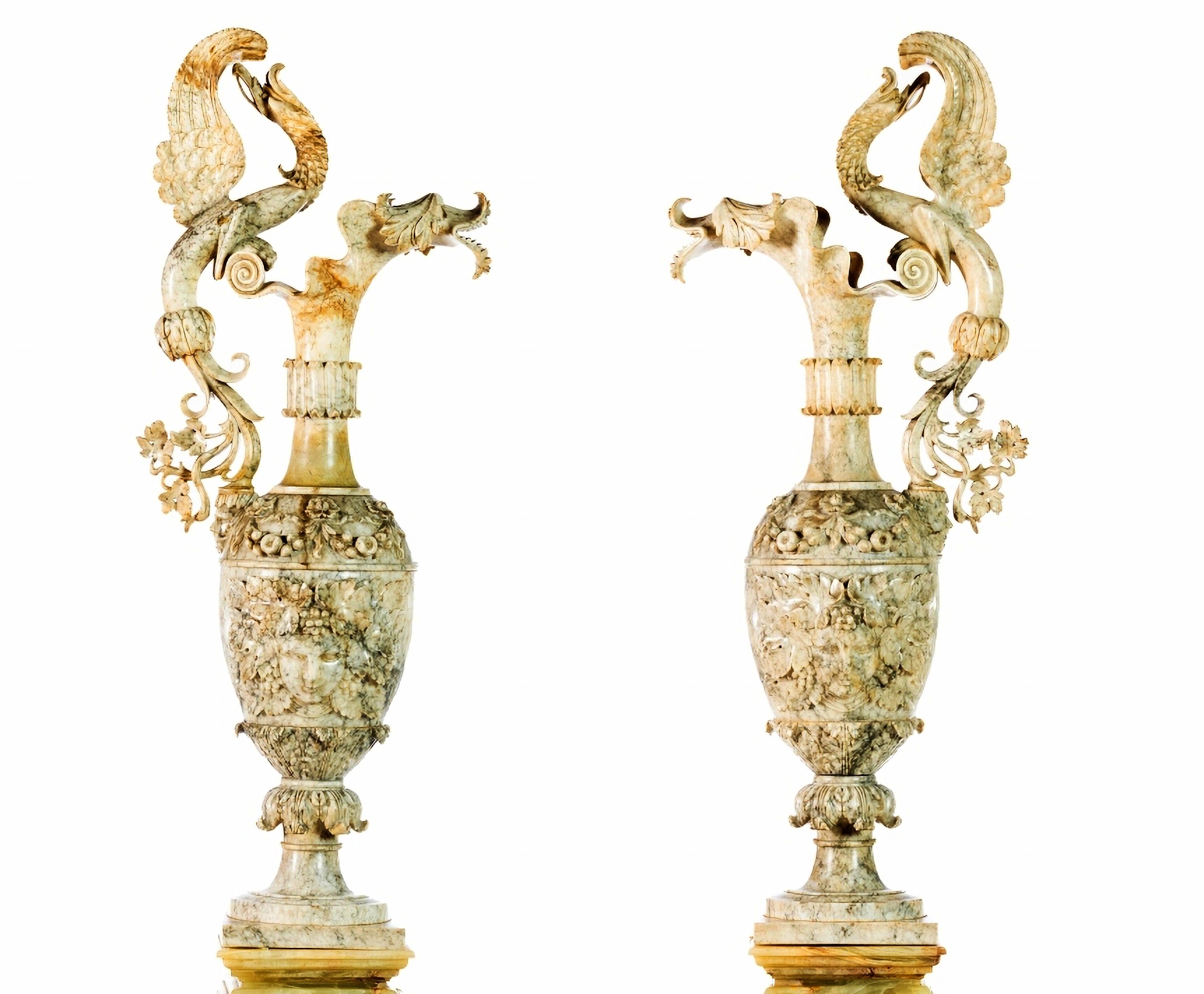 AMAZING PAIR OF ITALIAN LARGE AMPHORAS 19th Century

Italians, from the 19th century
in alabaster, with relief decoration representing plant motifs, fantastic animals and masks. 
Set on alabaster bases. 
Elecrified. 
Small defects and one with small