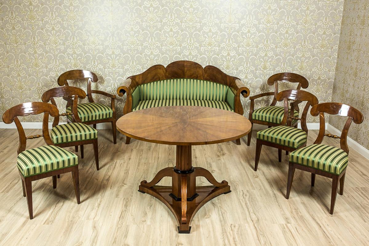We present you this set of furniture composed of a sofa, two armchairs, four chairs, and a round table. The furniture, circa 1840-1850, is kept in the stylistics typical for the Biedermeier style. The forms are simple and elegant, and they lack the