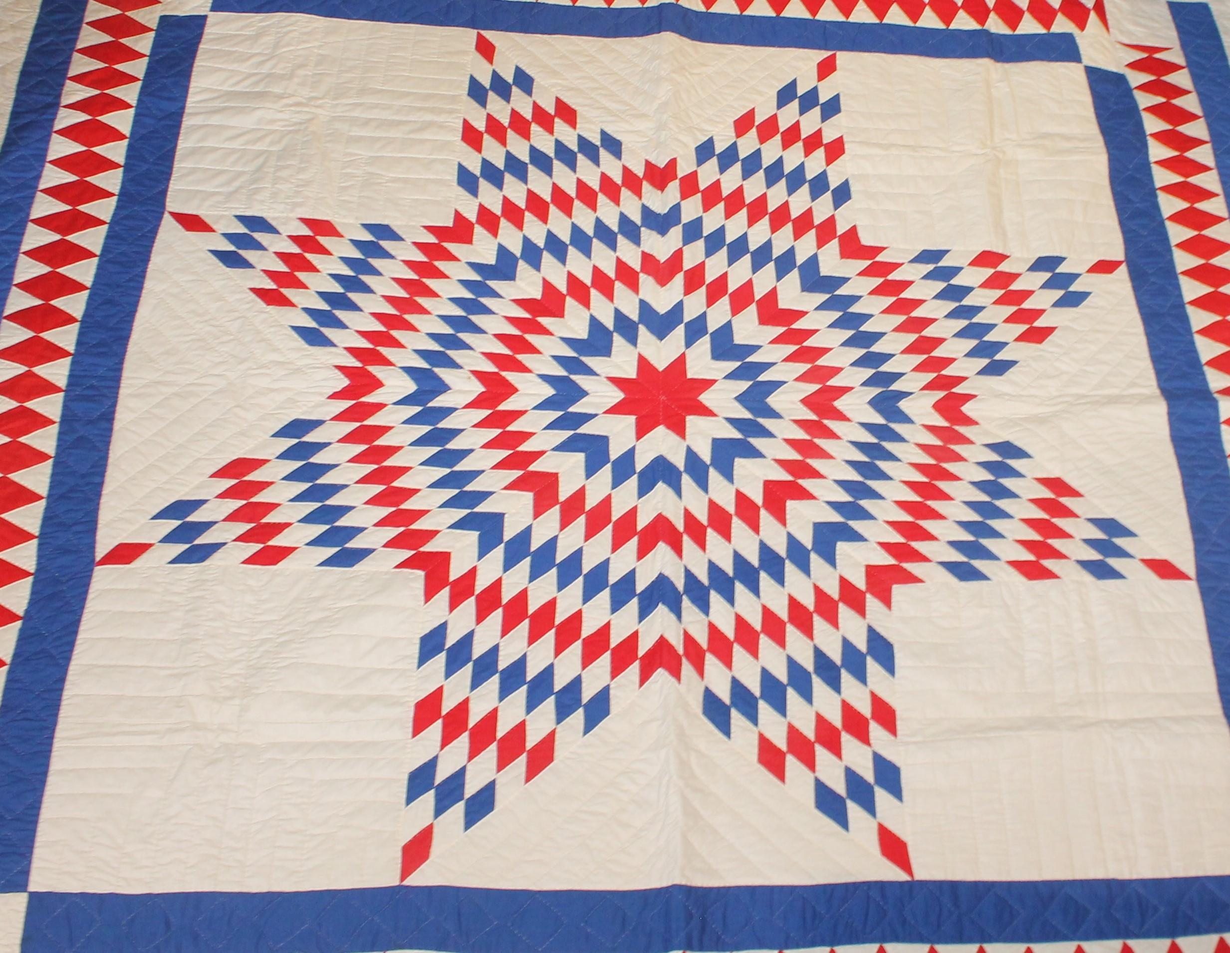 This fantastic red, white and blue star quilt from Pennsylvania has a wonderful diamond border. The piecework is very good and fine quilting. The condition is mint.