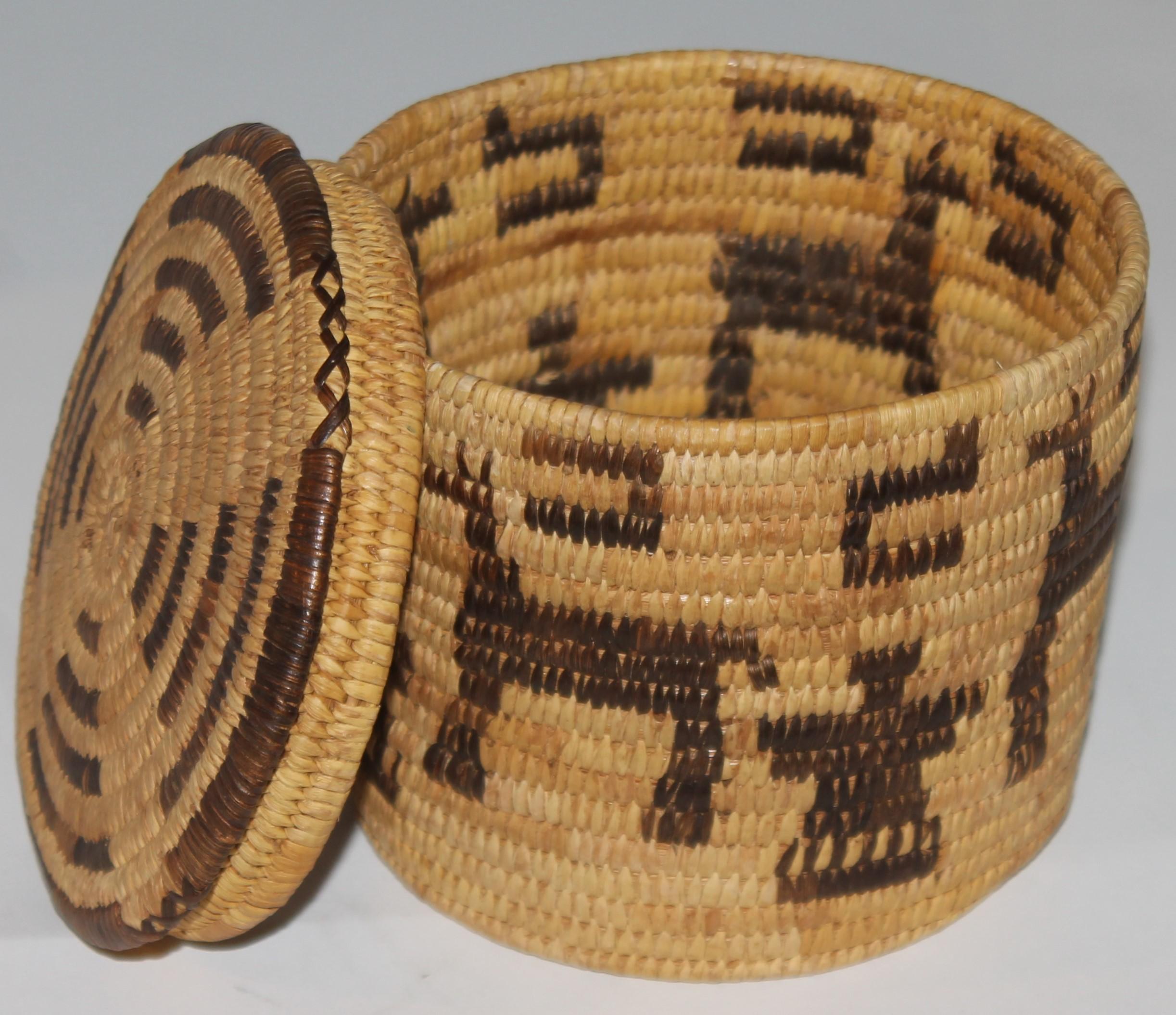 This amazing pictorial Indian basket with the original lid is in fine condition.