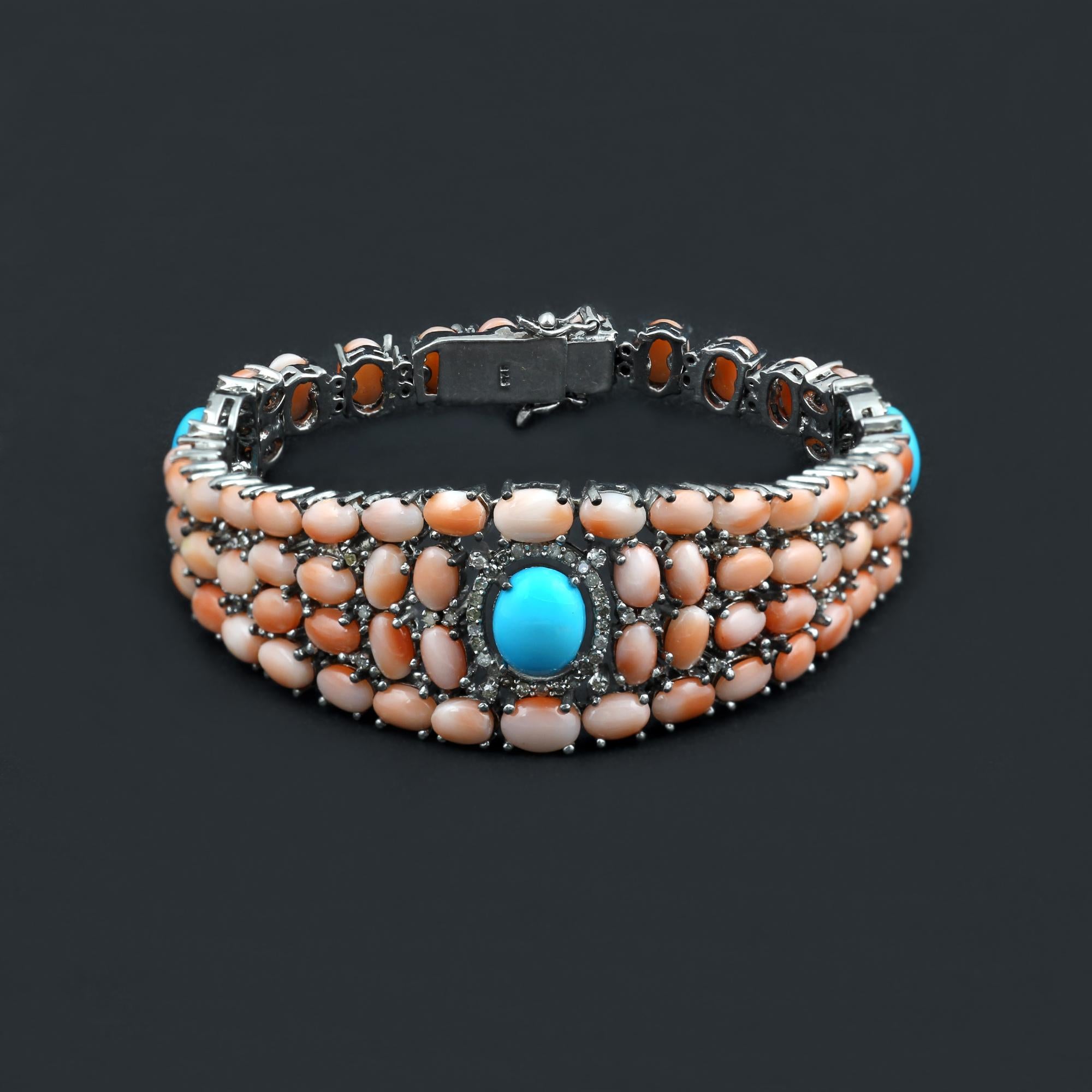 This one of a kind artisan made bracelet is beautiful to wear on any occasion. 
Made with 28 CT's of Natural Pink Corals, a rare gemstone, along with Big Sleeping beauty turquoise cabochons. 
Along with 1.5 Carats of the diamond, this bracelet is a